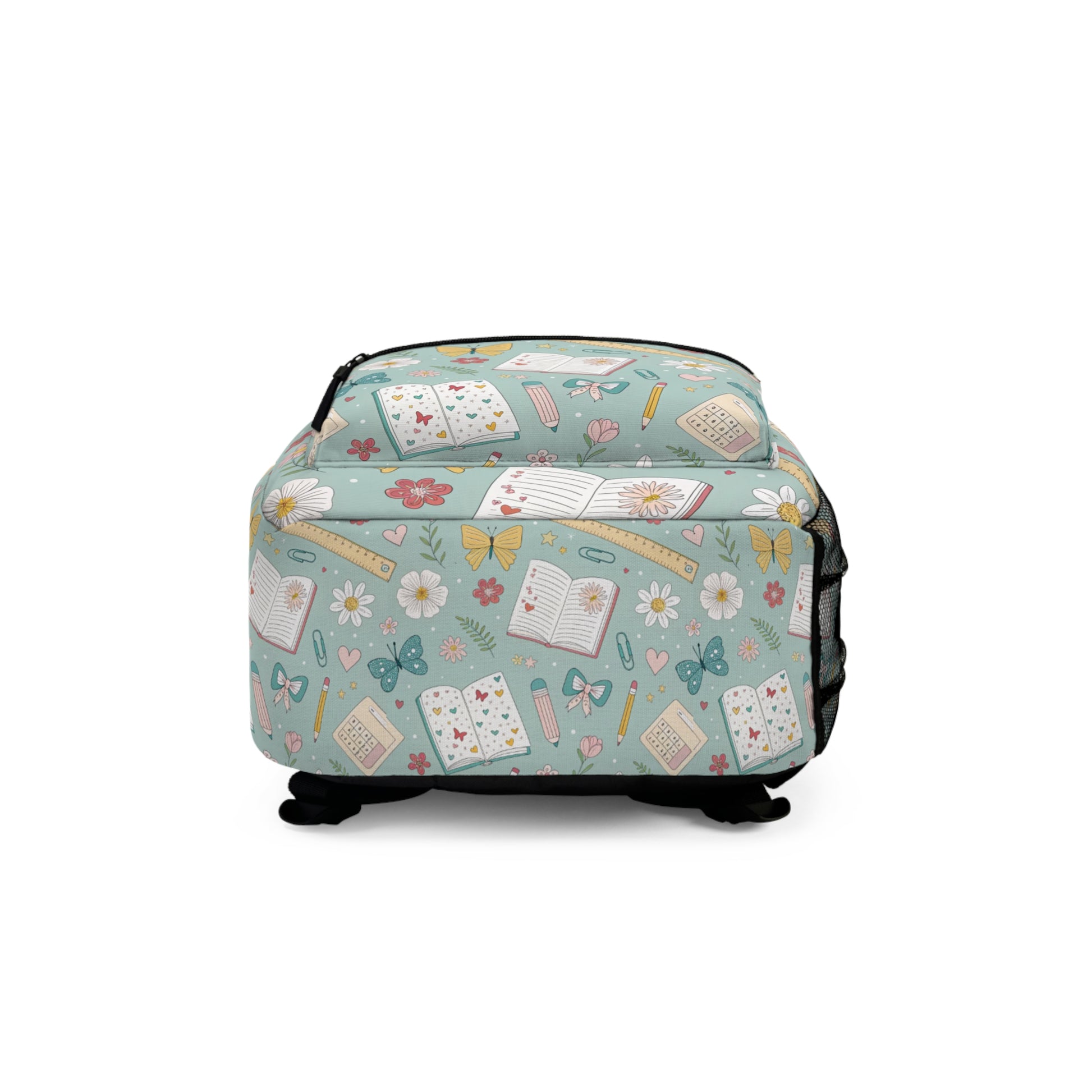 Light blue backpack with repeating pattern of books, flowers, butterflies, and school supplies.