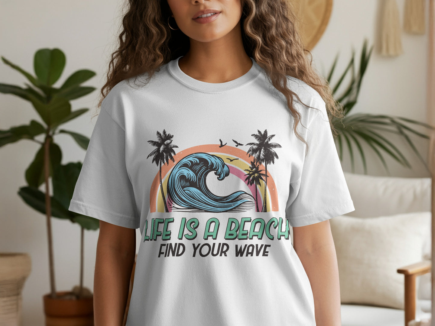 White t-shirt with colorful wave, palm trees, and "Life is a beach, find your wave" text.