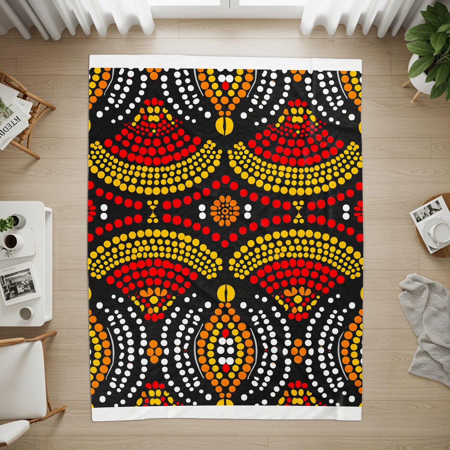 Black blanket with dot art pattern in red, yellow, orange, and white.