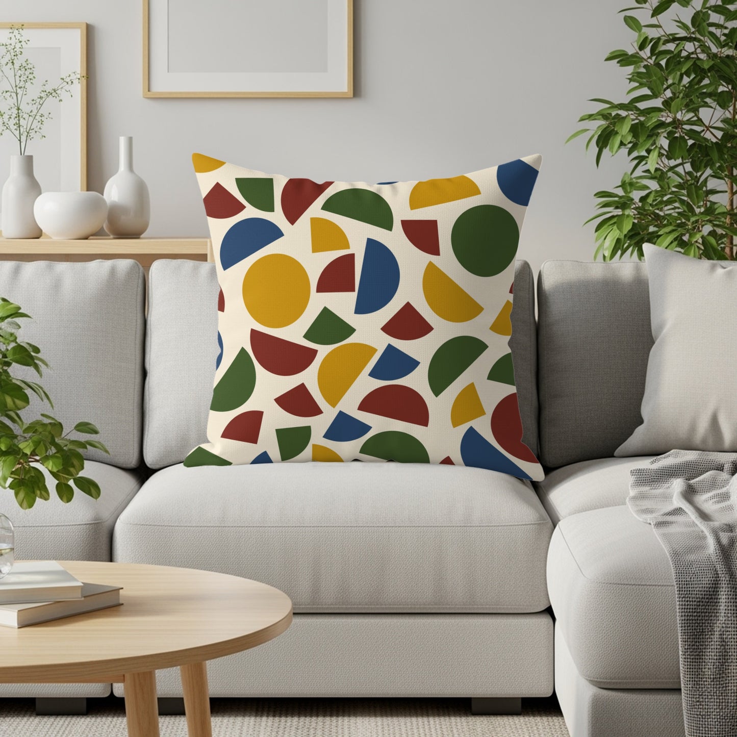 Cream pillow with abstract pattern of red, blue, yellow, and green geometric shapes.