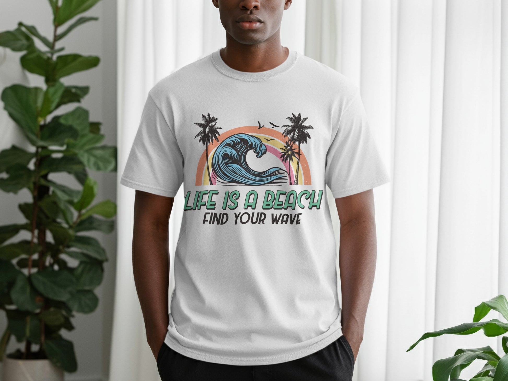White t-shirt with "Life is a Beach Find Your Wave" sunset surf graphic.