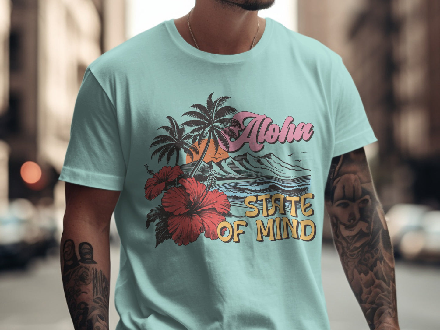 Light blue t-shirt with "Aloha State of Mind" graphic, palm trees, and ocean waves.