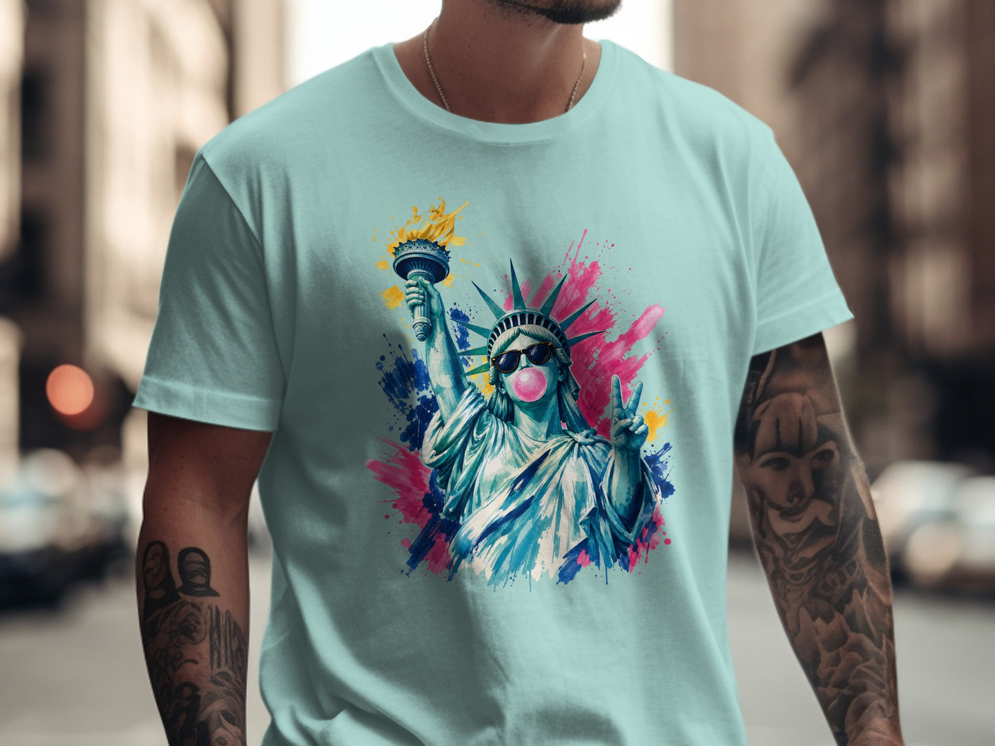 Light blue t-shirt with watercolor Statue of Liberty wearing sunglasses and blowing bubblegum.