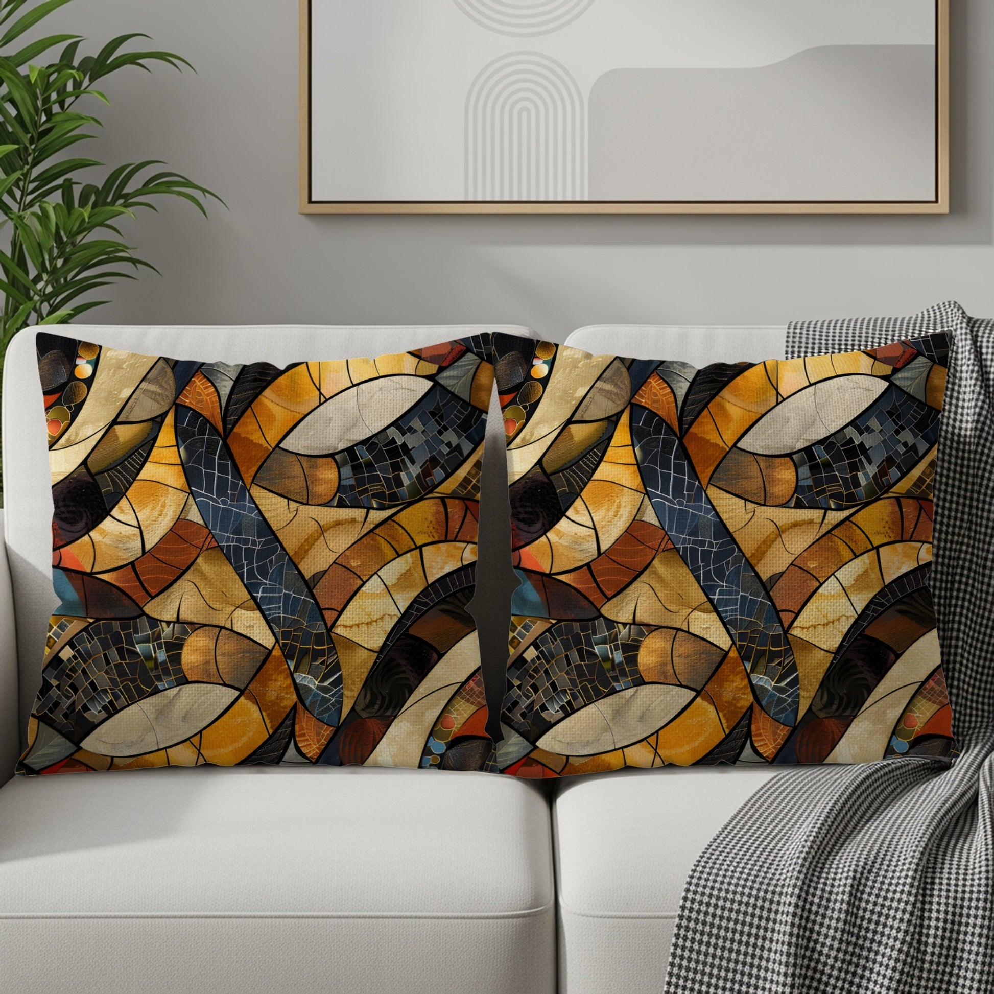 Two lumbar pillows with an abstract stained-glass pattern on a white couch.