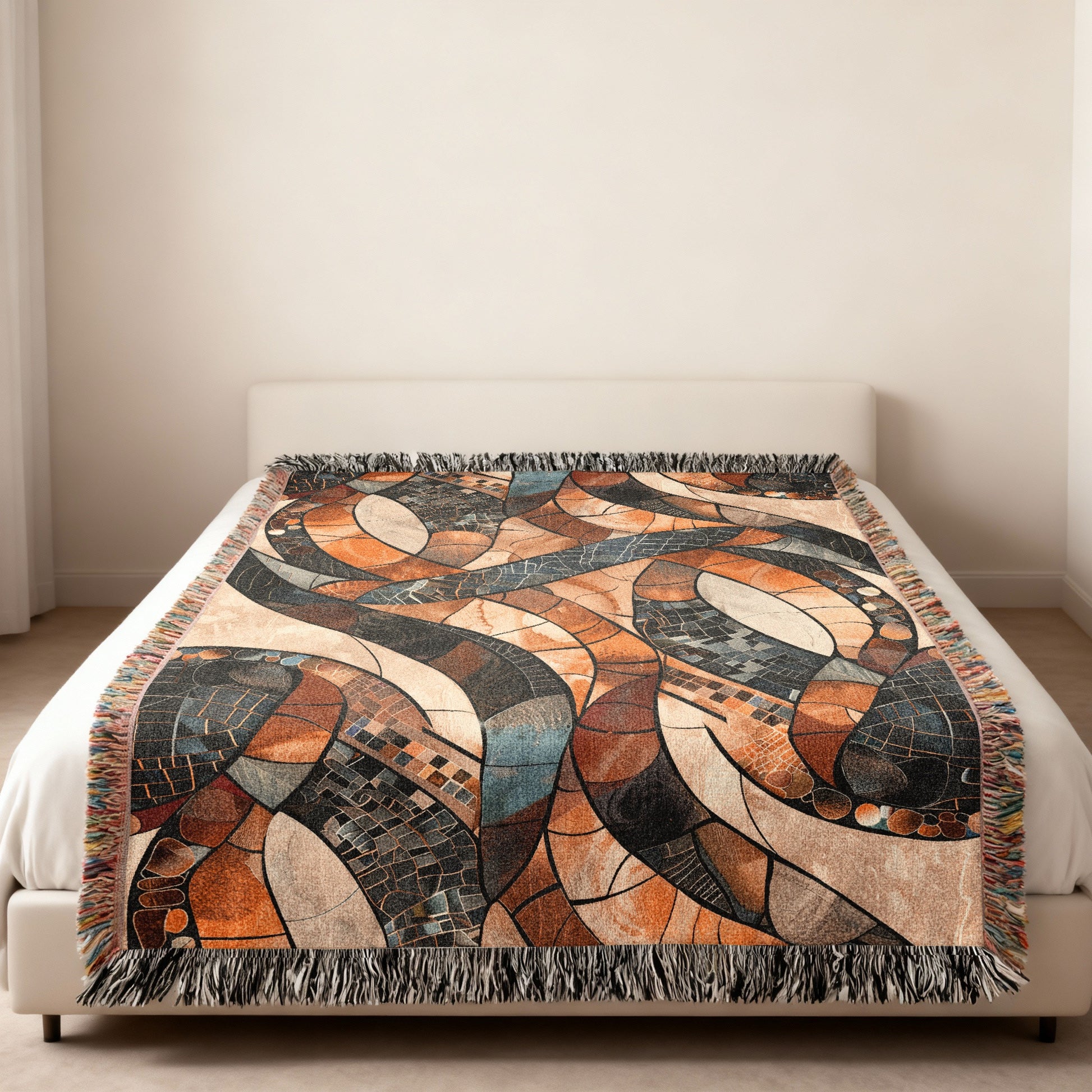 Woven throw blanket with abstract geometric pattern in brown, orange, and blue tones.