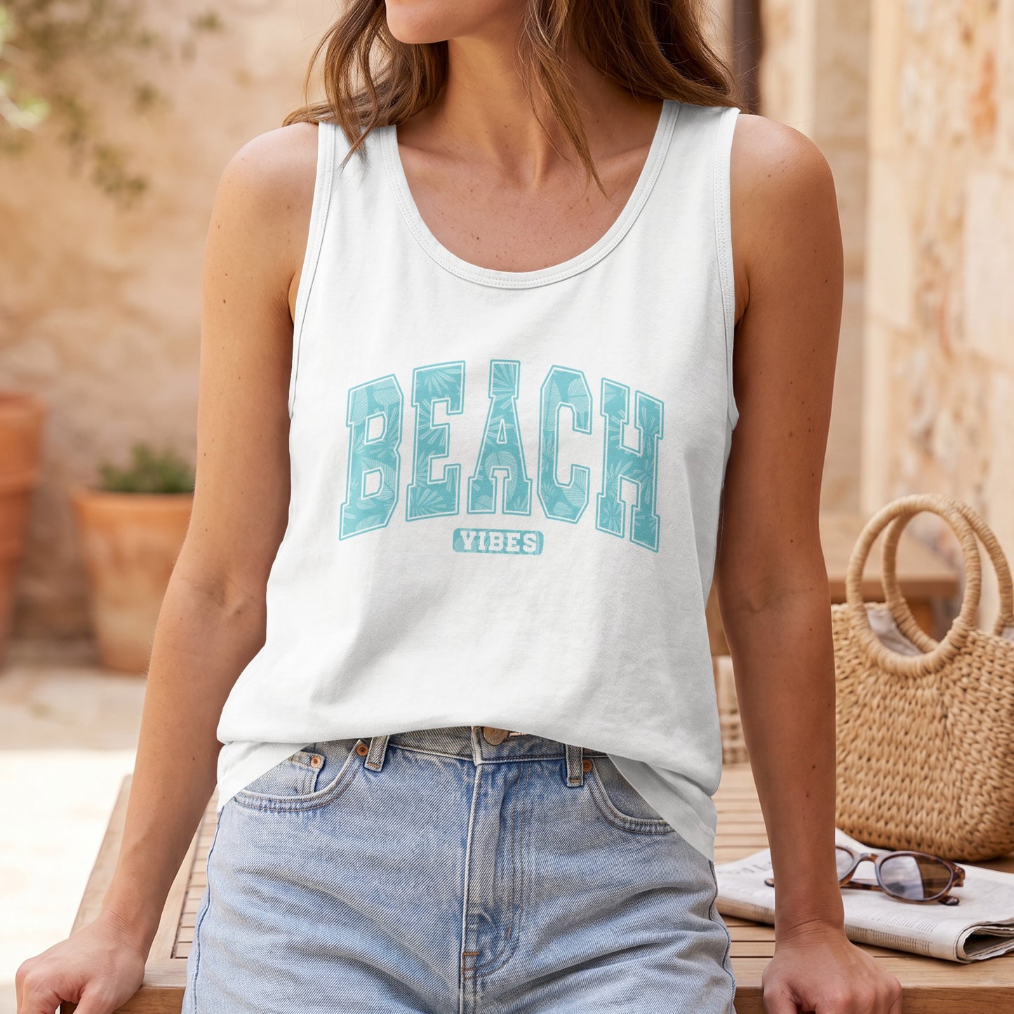 White tank top with "BEACH VIBES" text in light blue tropical leaf pattern.