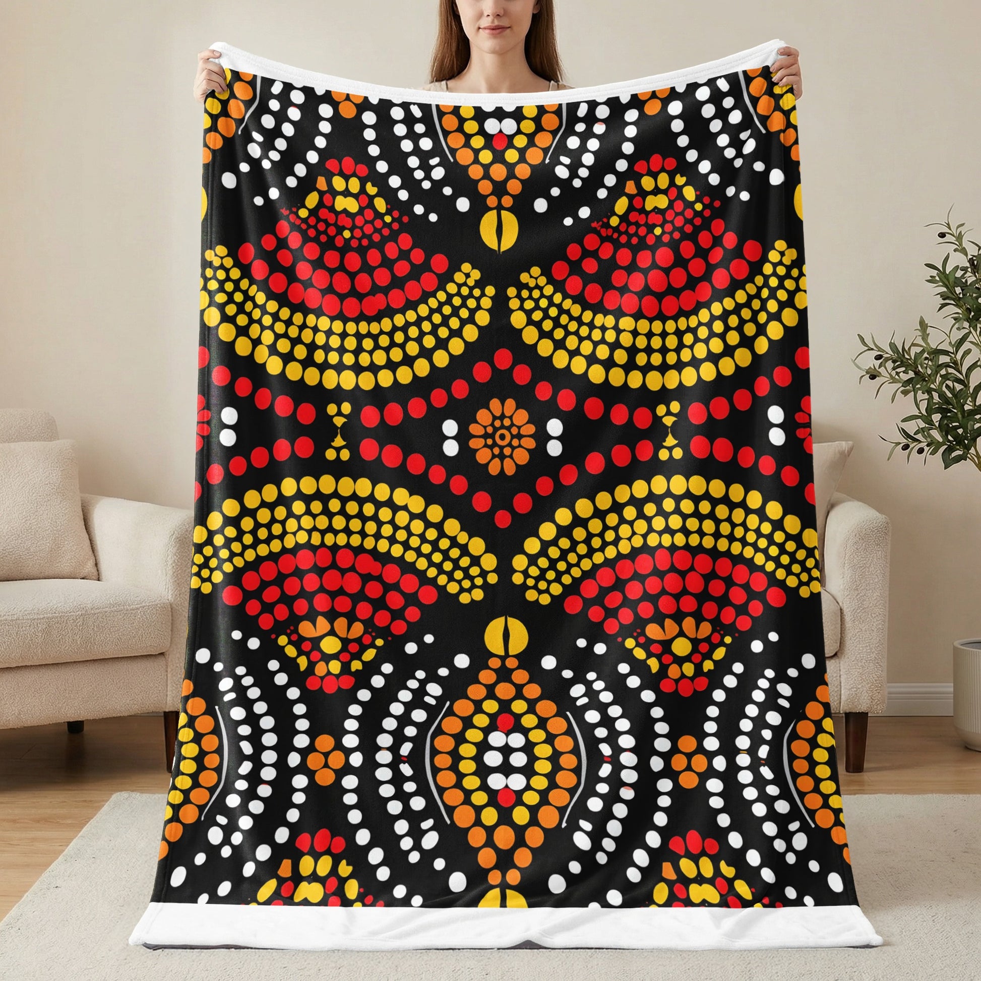 Black fleece blanket with red, yellow, and white dot art pattern.