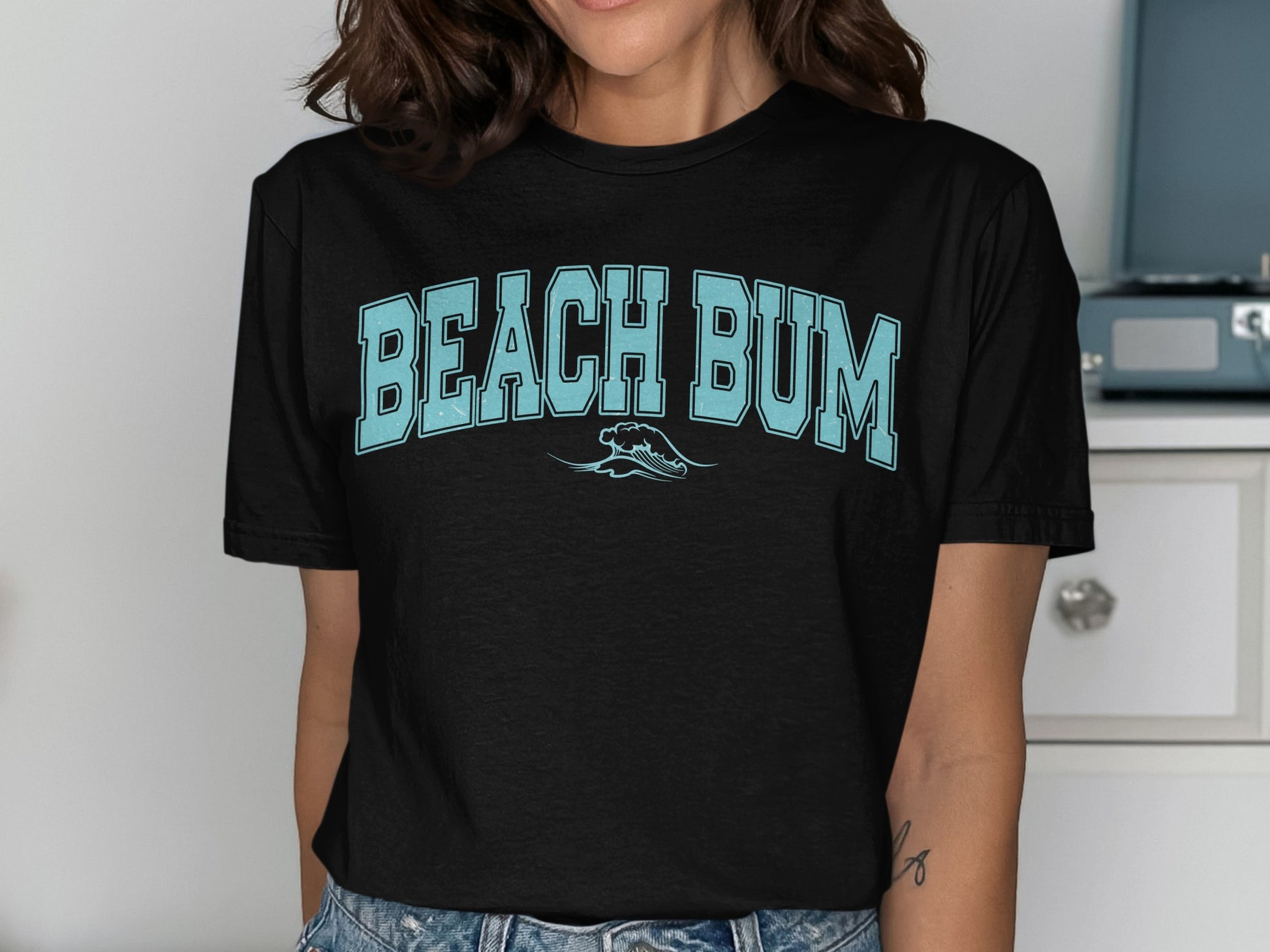 Black t-shirt with light blue "BEACH BUM" text and a wave graphic.