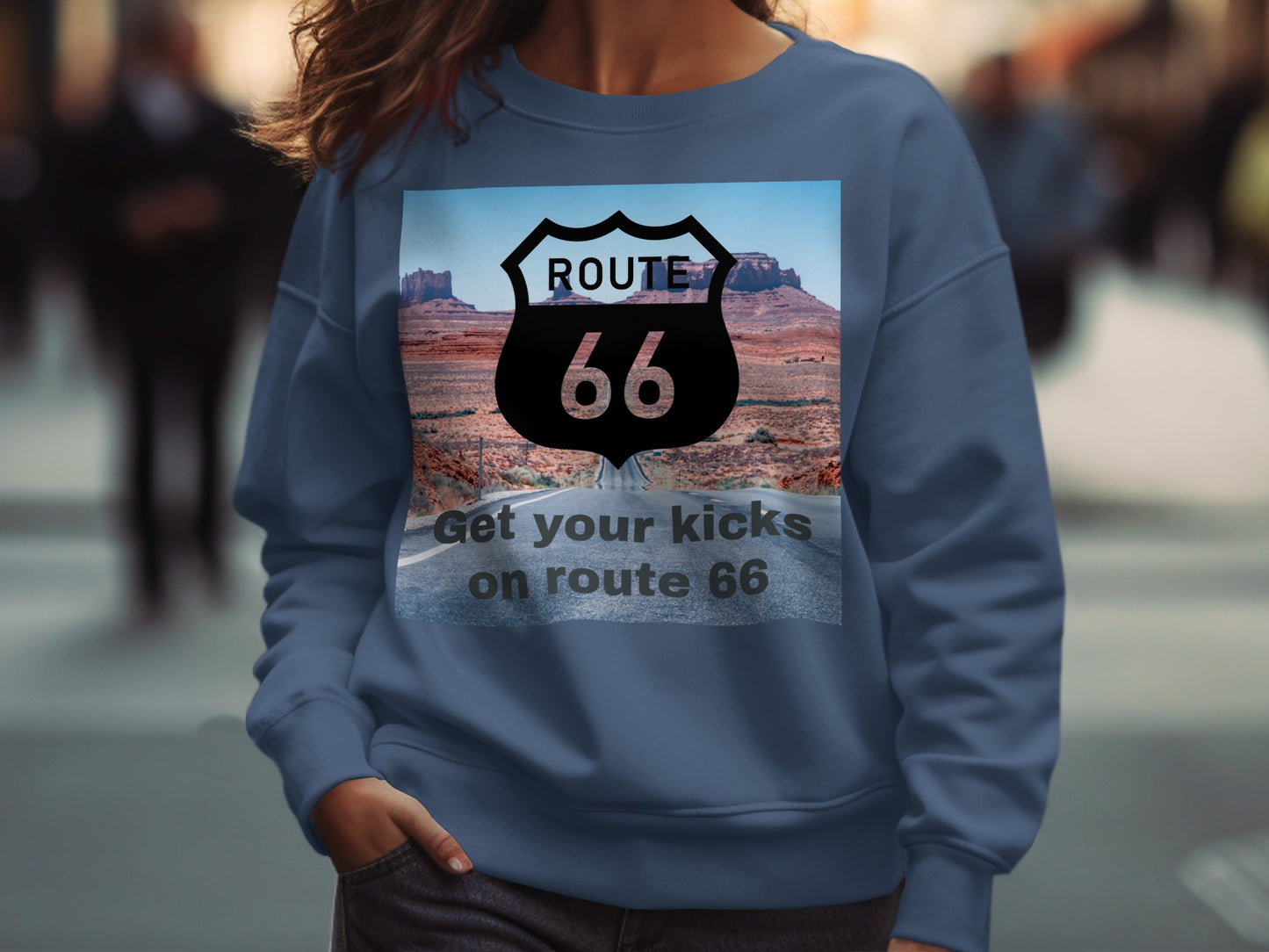 Blue sweatshirt with Route 66 graphic featuring Monument Valley and text.
