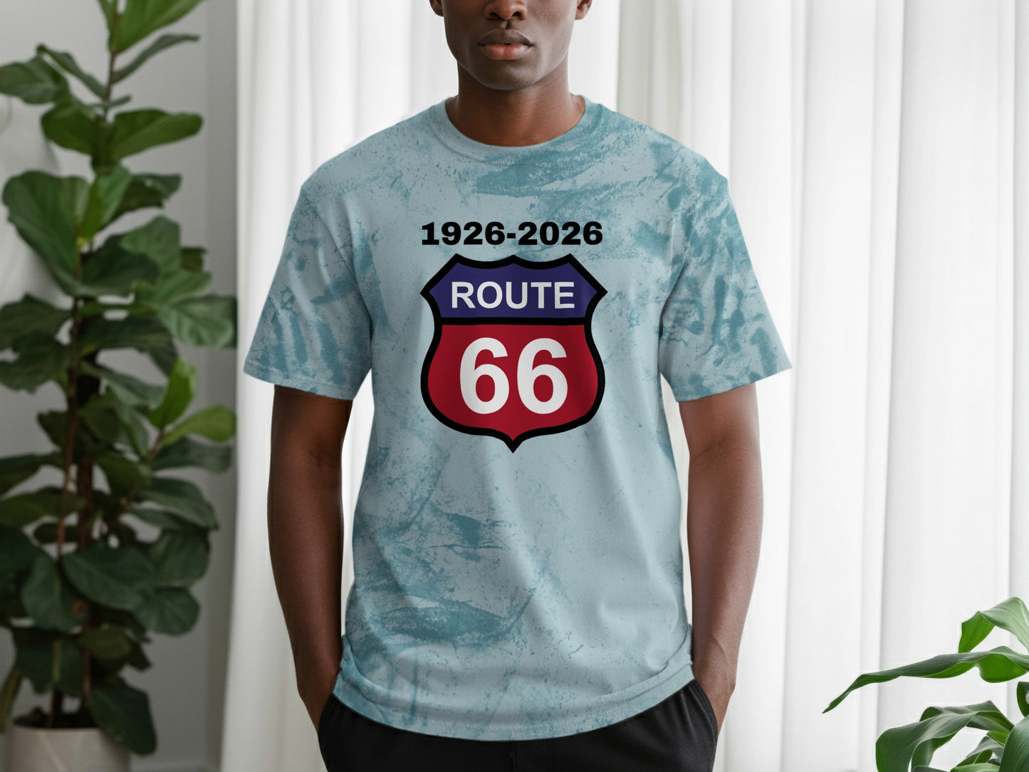 Man wearing light blue tie-dye t-shirt with Route 66 shield logo and dates.