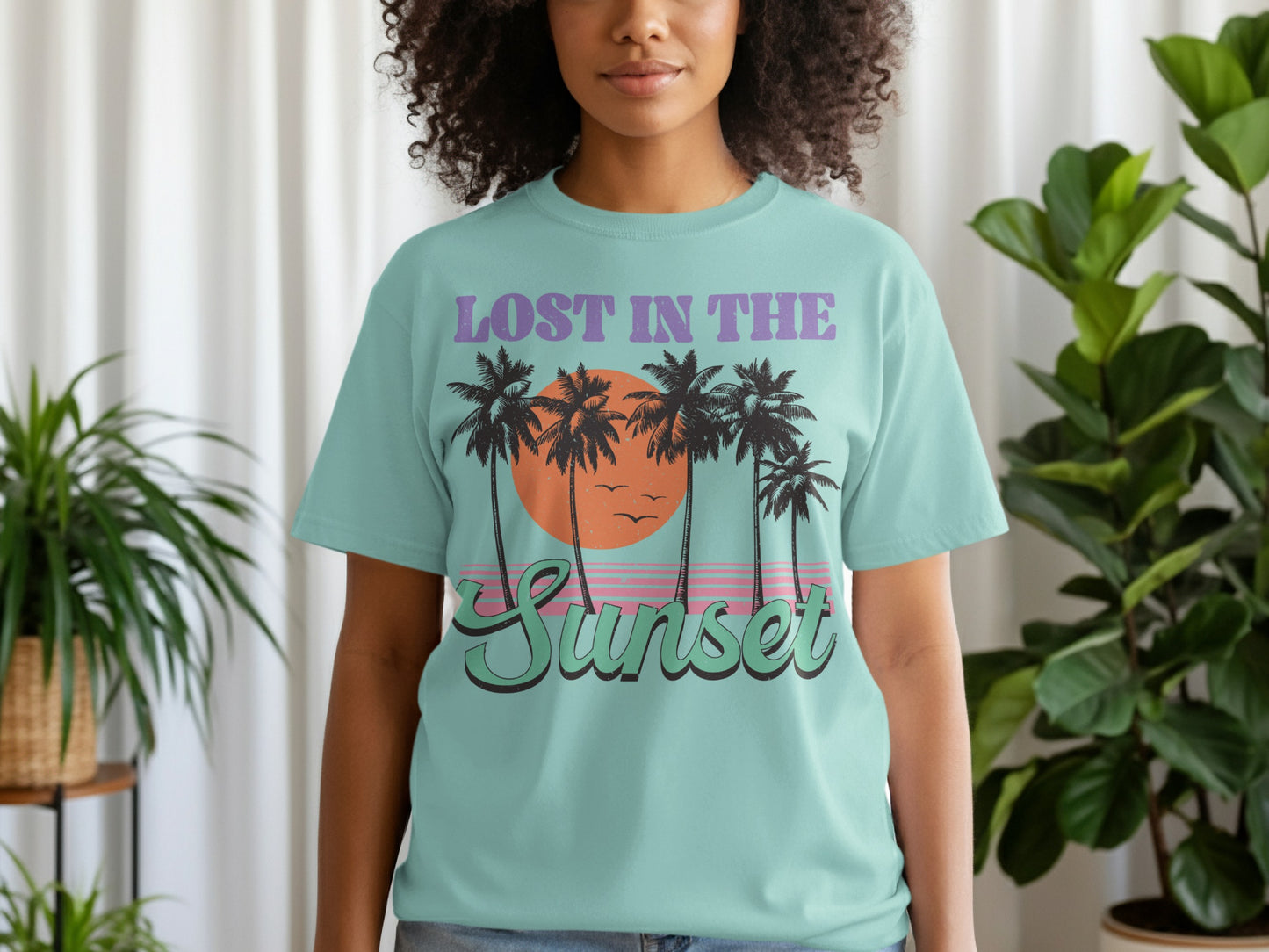 Mint green t-shirt with "LOST IN the SUNSET" and palm trees graphic.