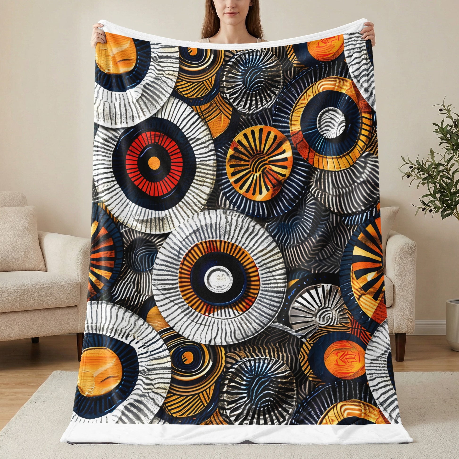 Abstract circular pattern with orange, blue, and metallic silver tones on a blanket.