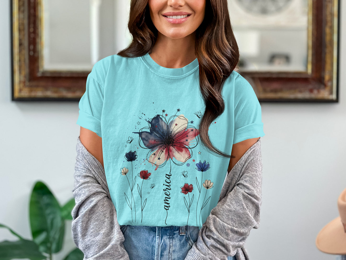 Light blue t-shirt with watercolor flower and "America" text.