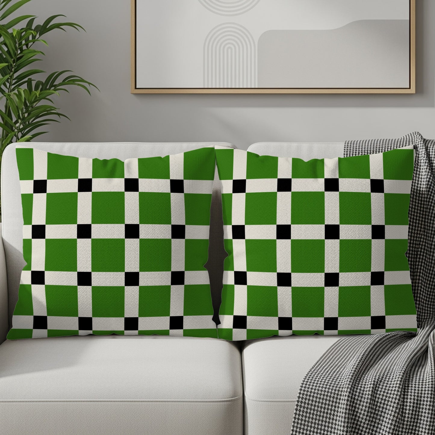 Two lumbar pillows with a green, white, and black checkerboard pattern on a sofa.