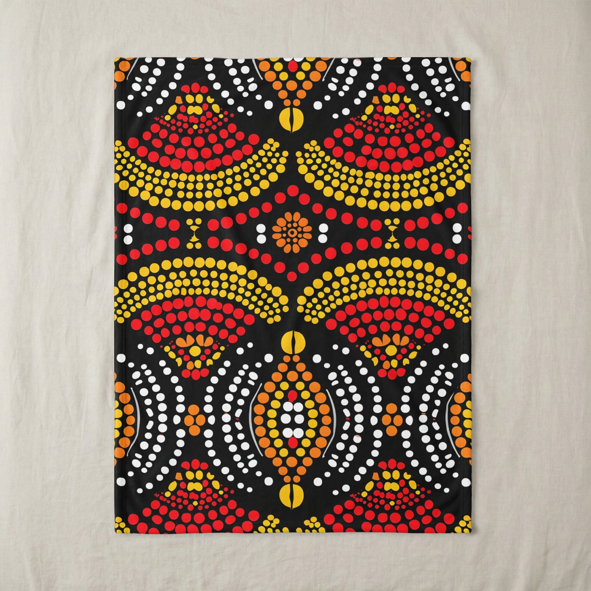 Black textile with a symmetrical dot pattern in red, yellow, orange, and white.