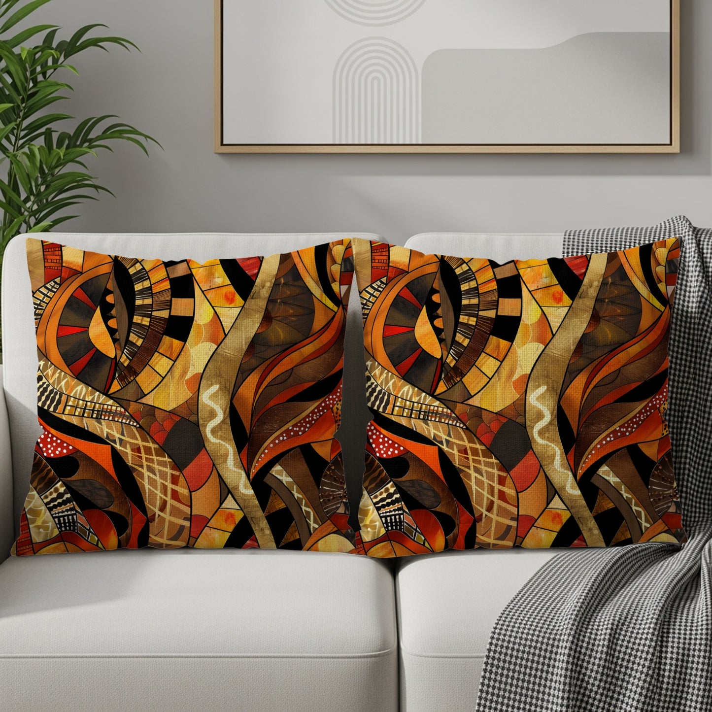 Two throw pillows with abstract geometric patterns in warm tones on a white sofa.