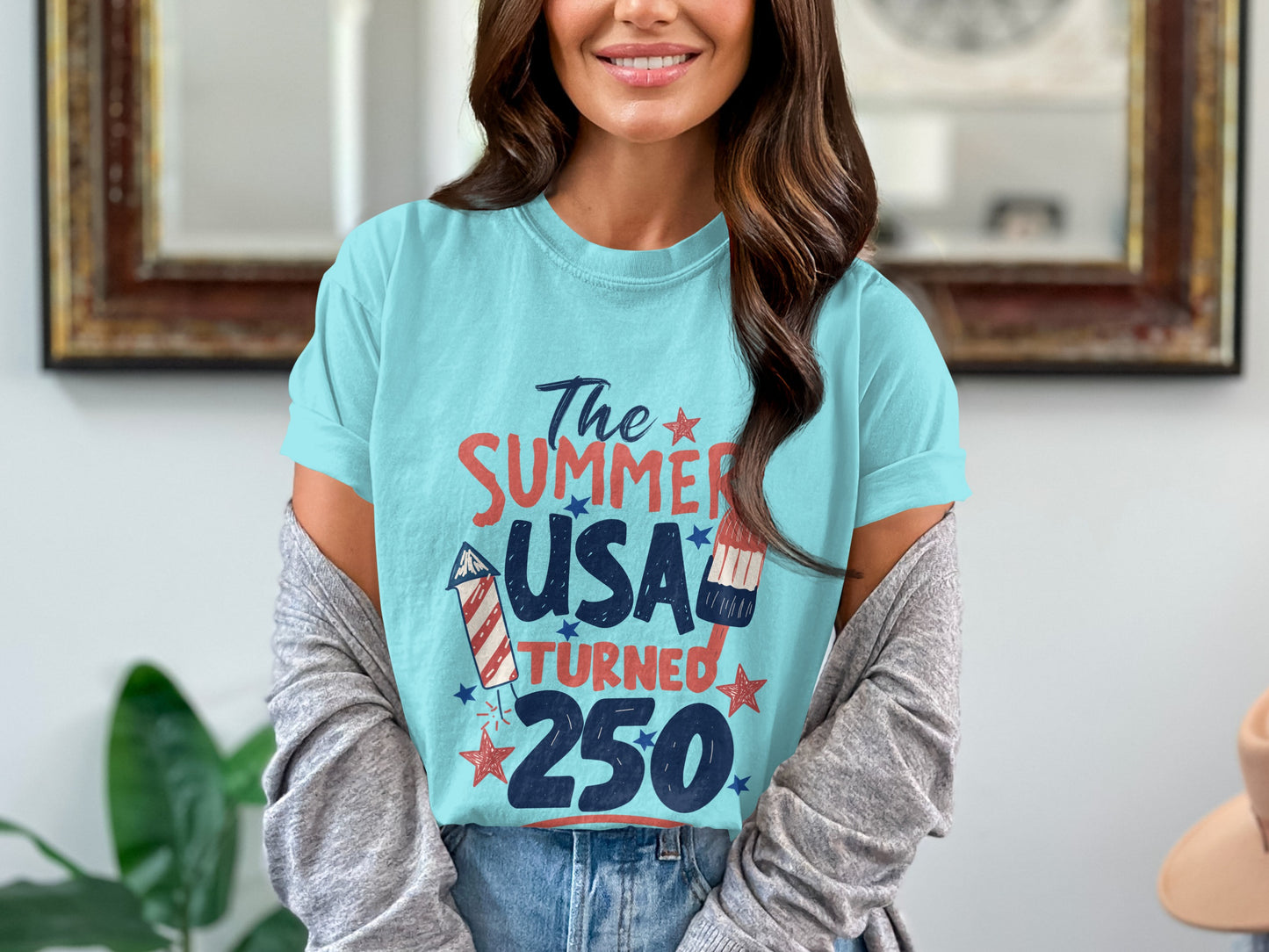 Light blue t-shirt with "The Summer USA Turned 250" graphic and fireworks.