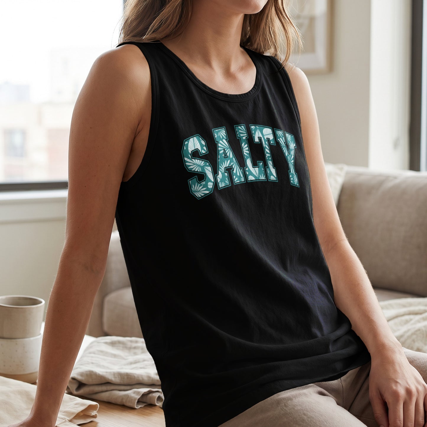 Black tank top with "SALTY" text in a green leaf pattern.