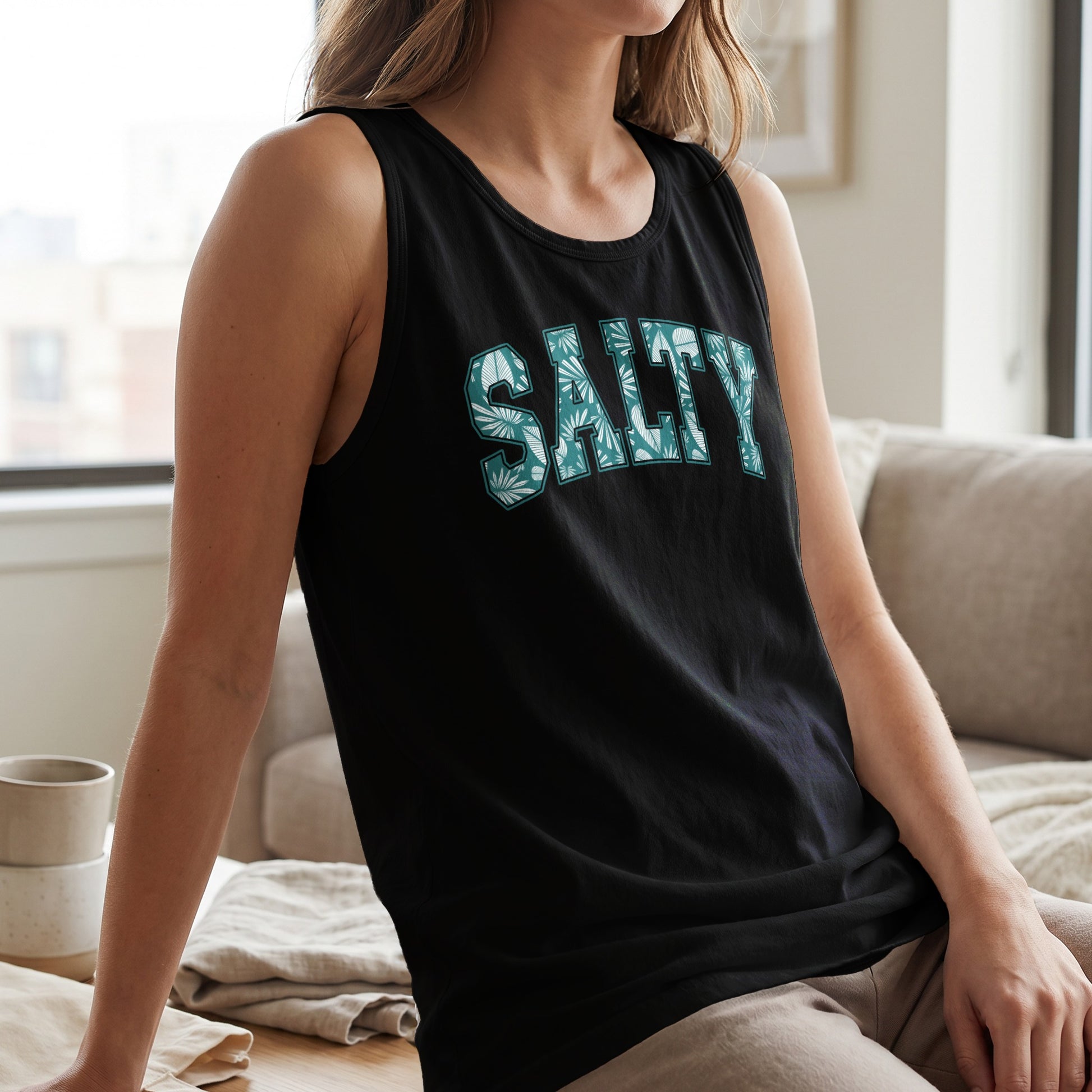 Black tank top with "SALTY" text in a green leaf pattern.
