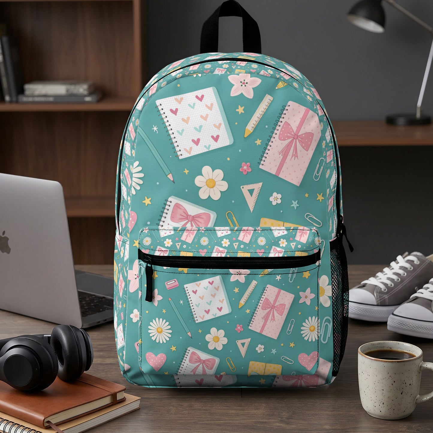 Teal backpack with a pattern of notebooks, gifts, flowers, and school supplies.