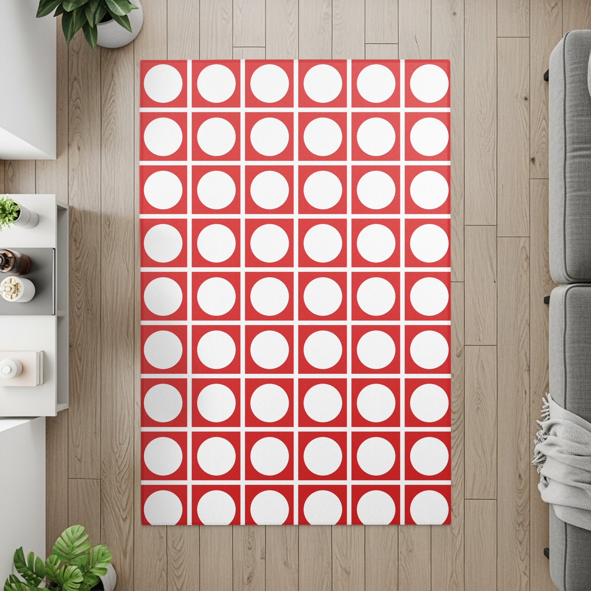 Red and white circular dot pattern rug on a wood floor.