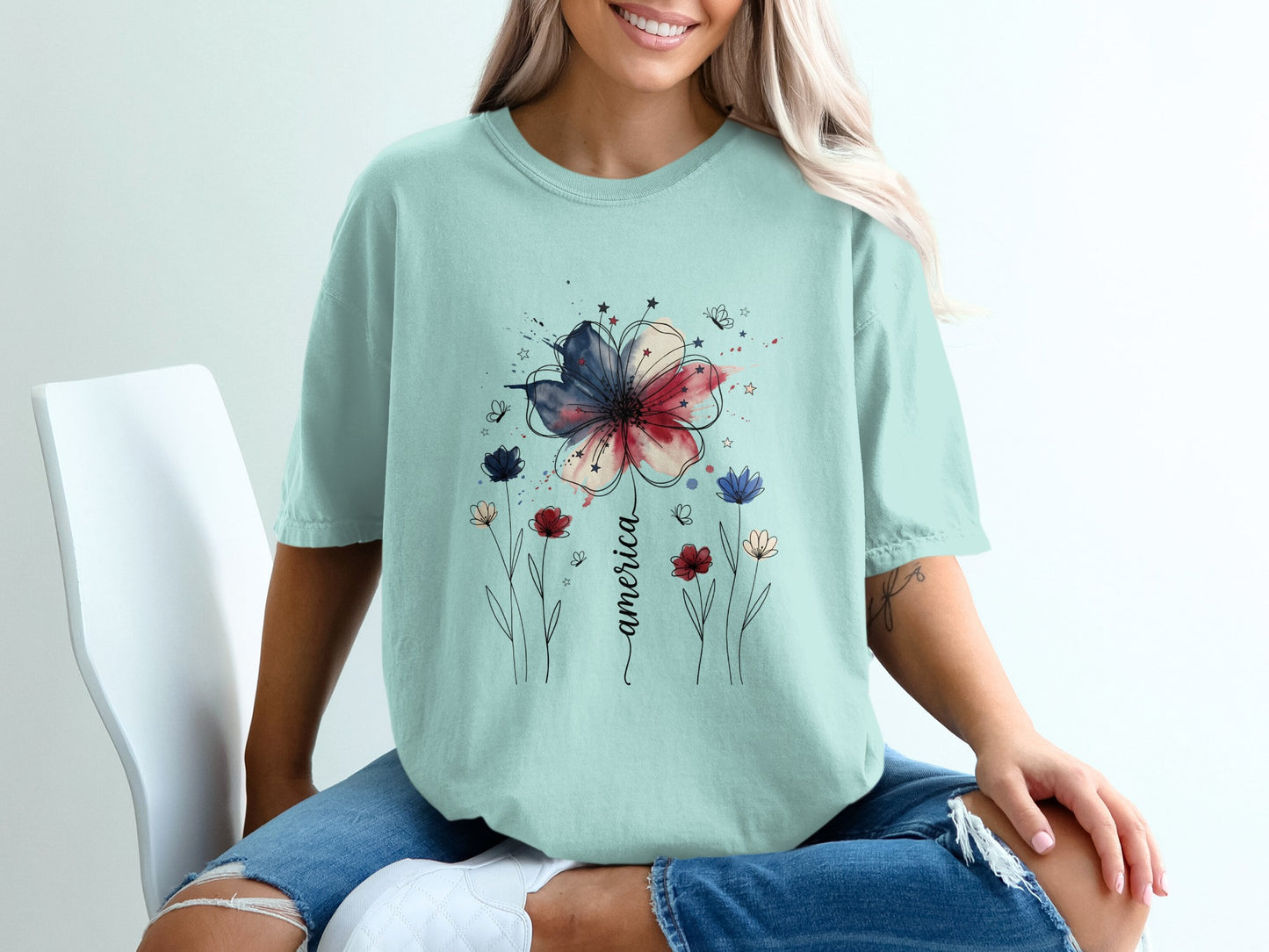 Light blue t-shirt with a watercolor flower and stars design.