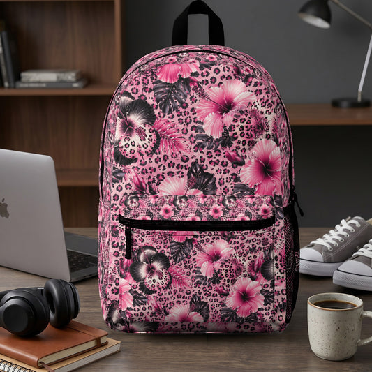 Pink backpack with hibiscus flowers and leopard print pattern.