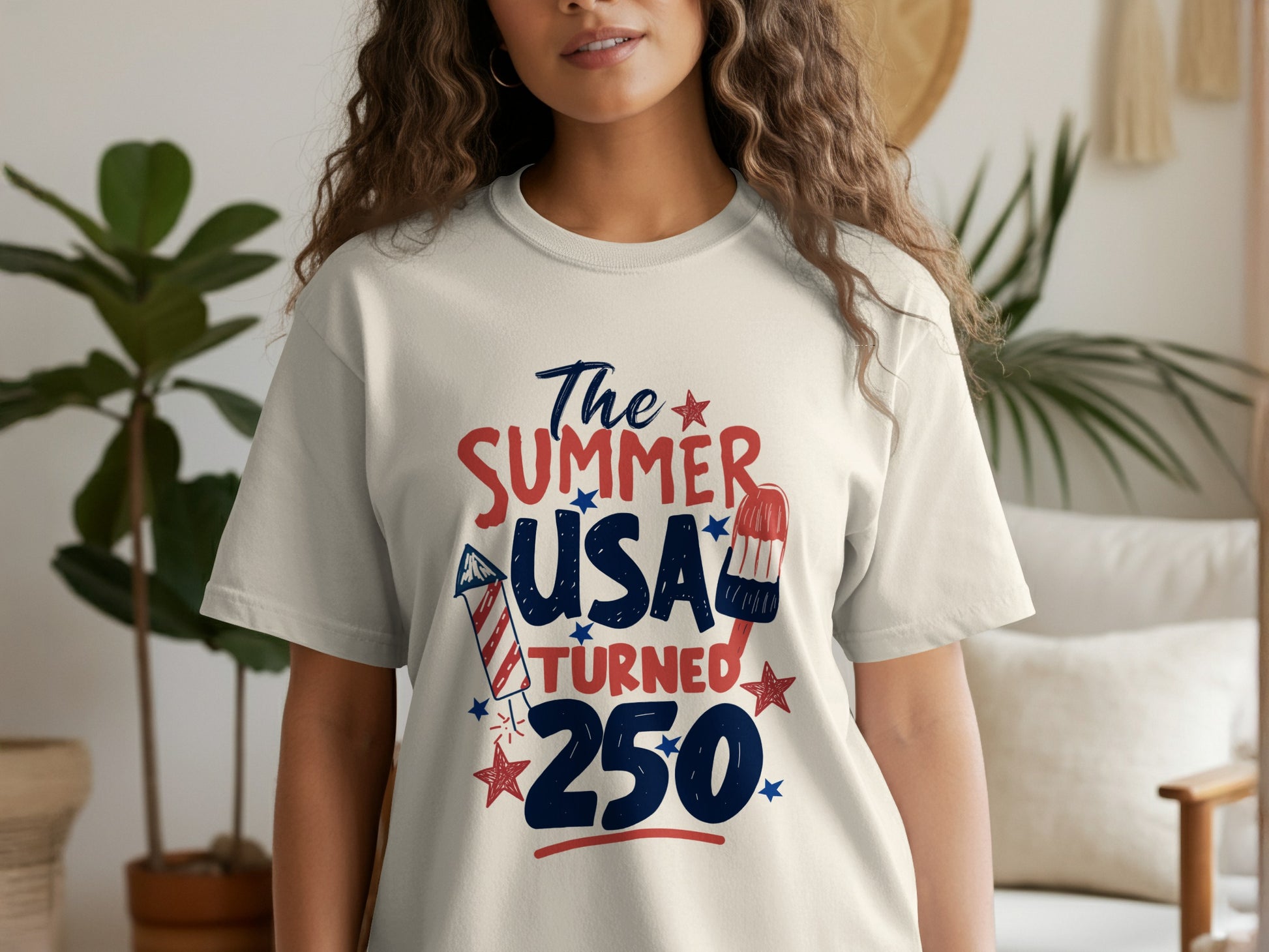 Red, white, and blue "The Summer USA Turned 250" graphic on a white t-shirt.