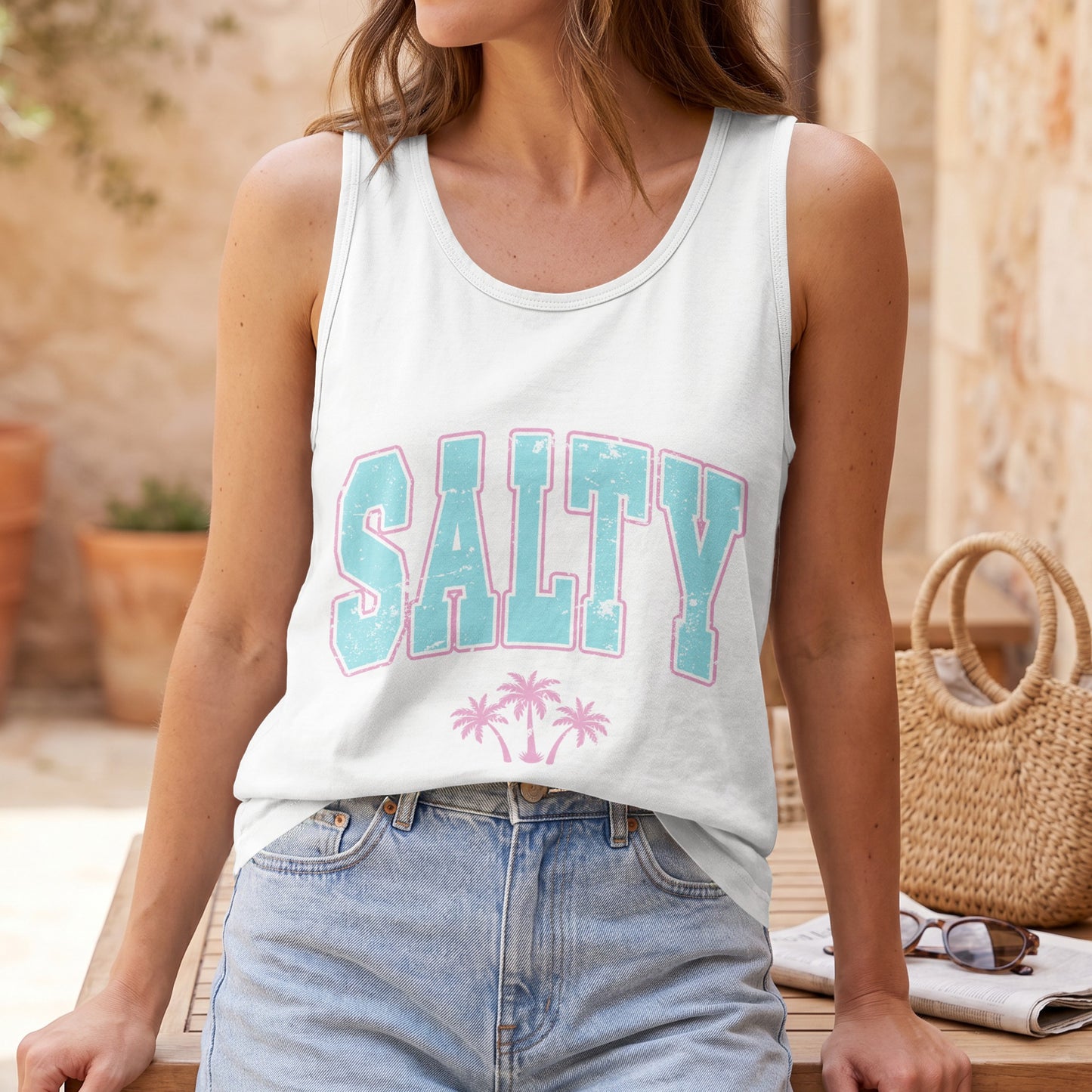 White tank top with "SALTY" in blue and pink lettering, palm trees.