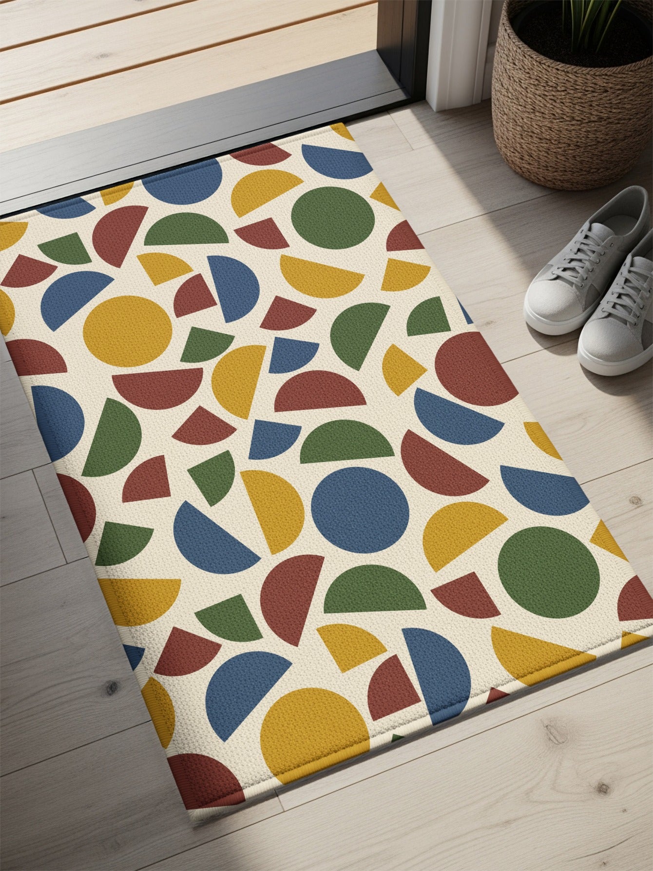 Rug with cream background and a pattern of scattered circles and semicircles in blue, yellow, green, and red.