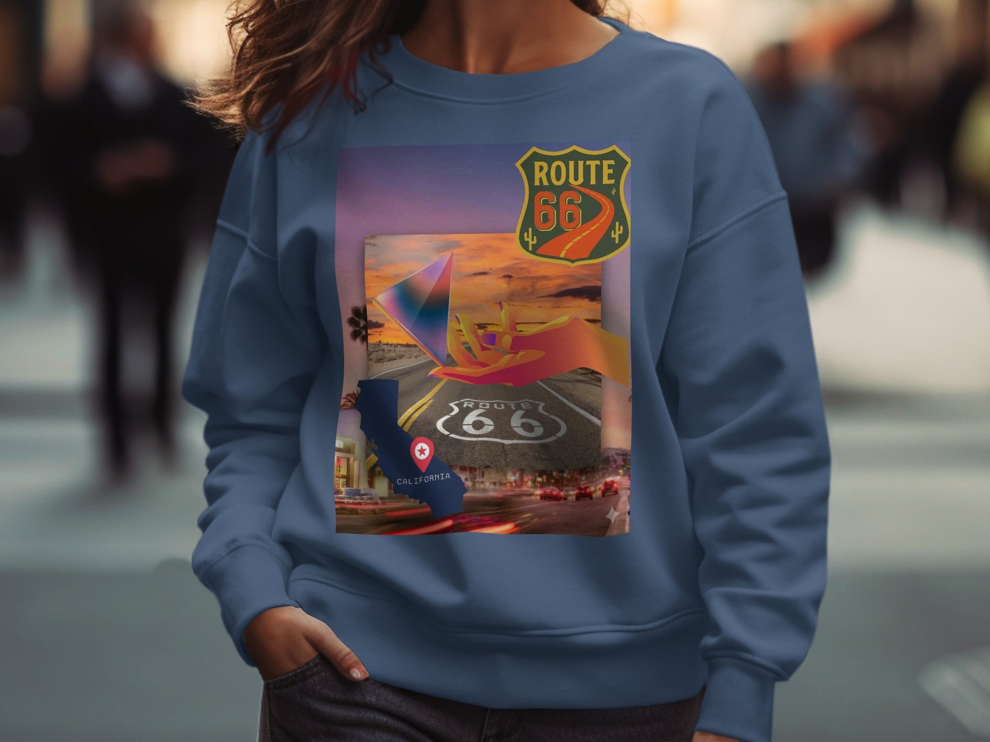 Blue sweatshirt with a Route 66 California map and sunset graphic.