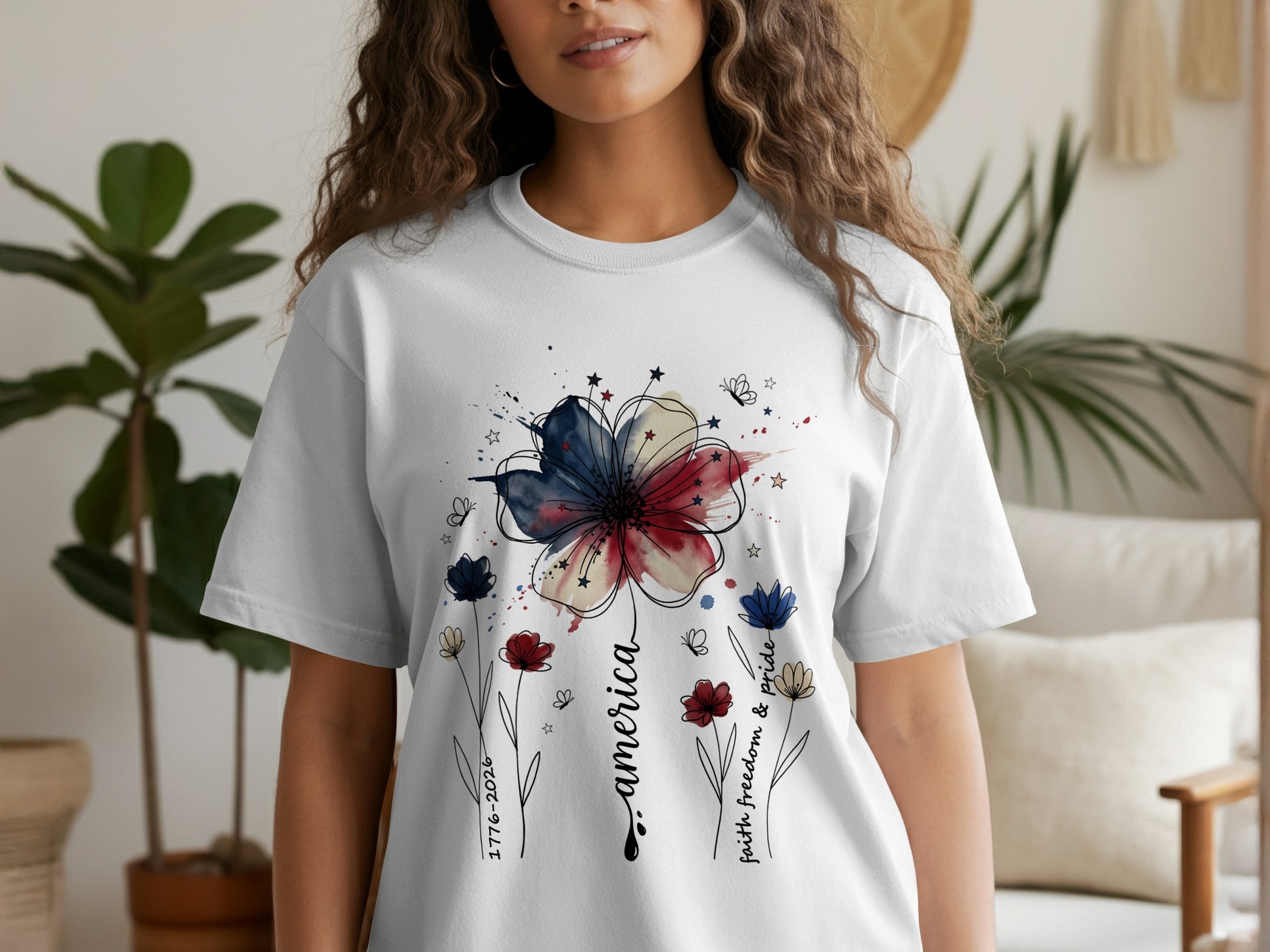 White t-shirt with red, white, and blue floral America design and patriotic text.