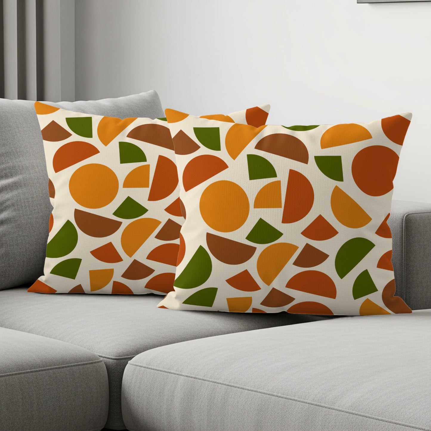 Two throw pillows with a cream background and a geometric pattern of circles and semi-circles.