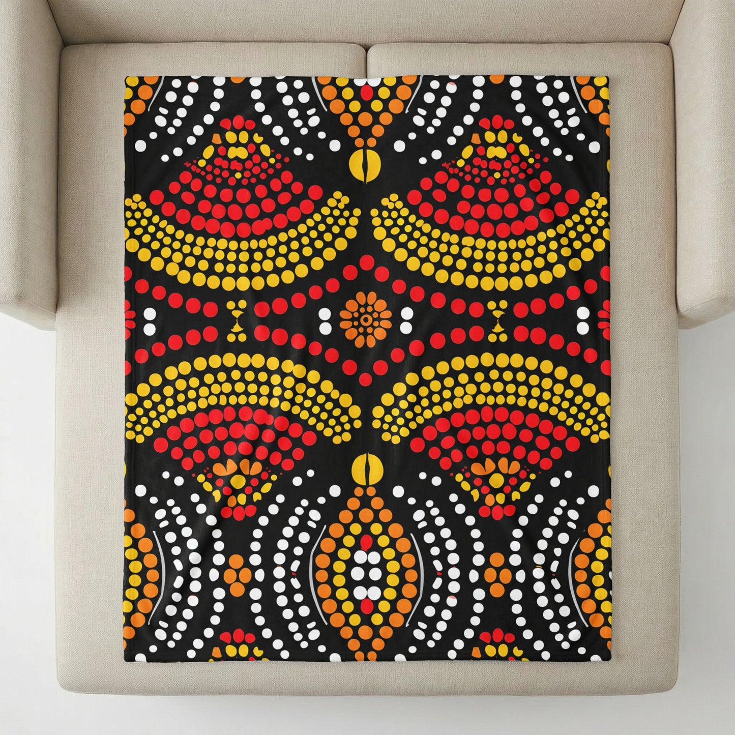 Black blanket with dot art pattern featuring red, yellow, orange, and white circles.