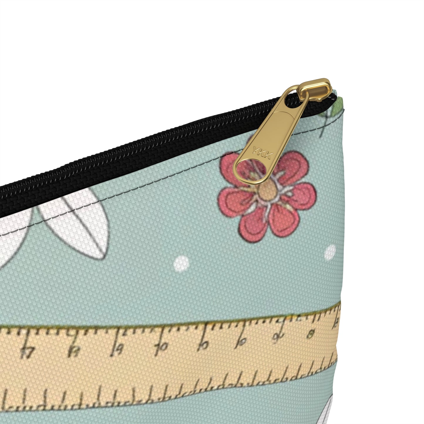 Cosmetic bag with a YKK zipper, ruler pattern, flowers, and leaves.
