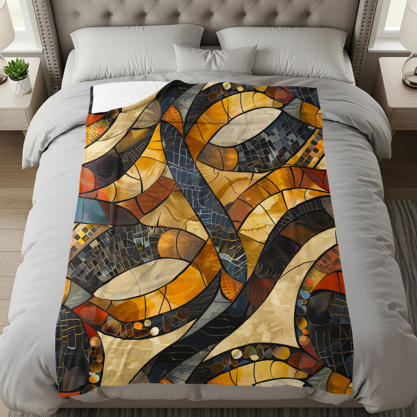 Throw blanket with a stained-glass inspired abstract mosaic pattern in warm tones.