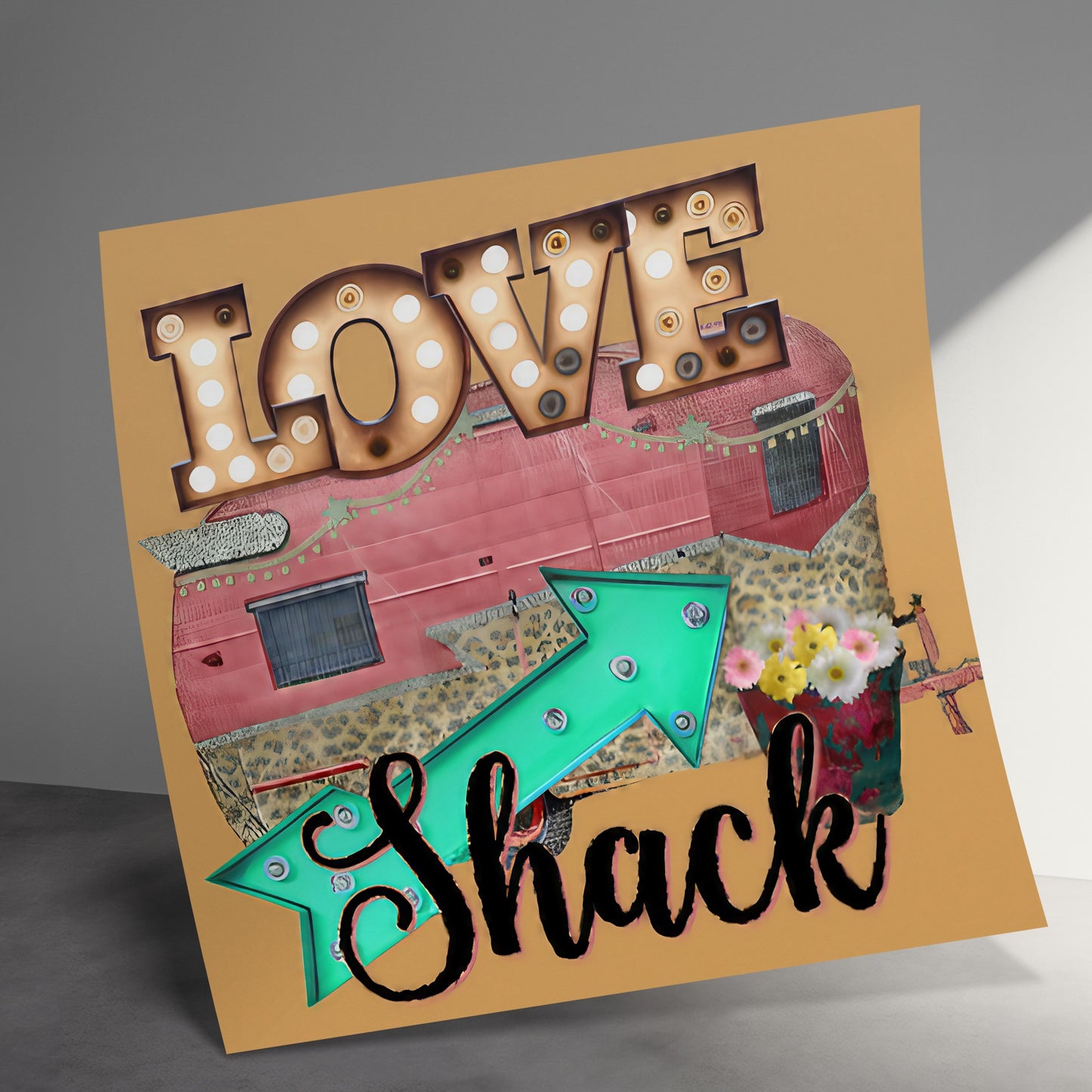 "Love Shack" marquee sign and arrow over vintage camper with flowers.