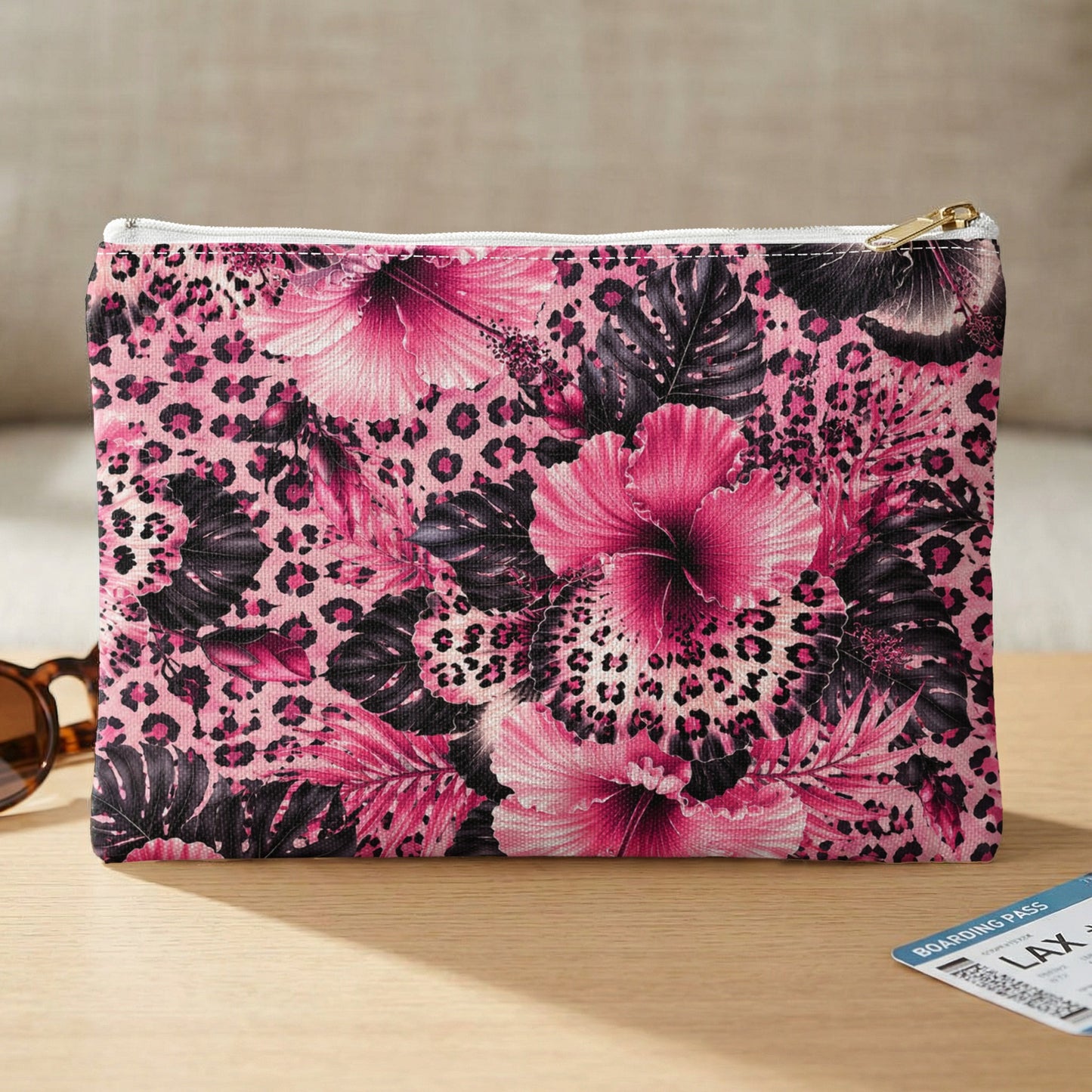 Pink leopard print and hibiscus floral patterned pouch with gold zipper.