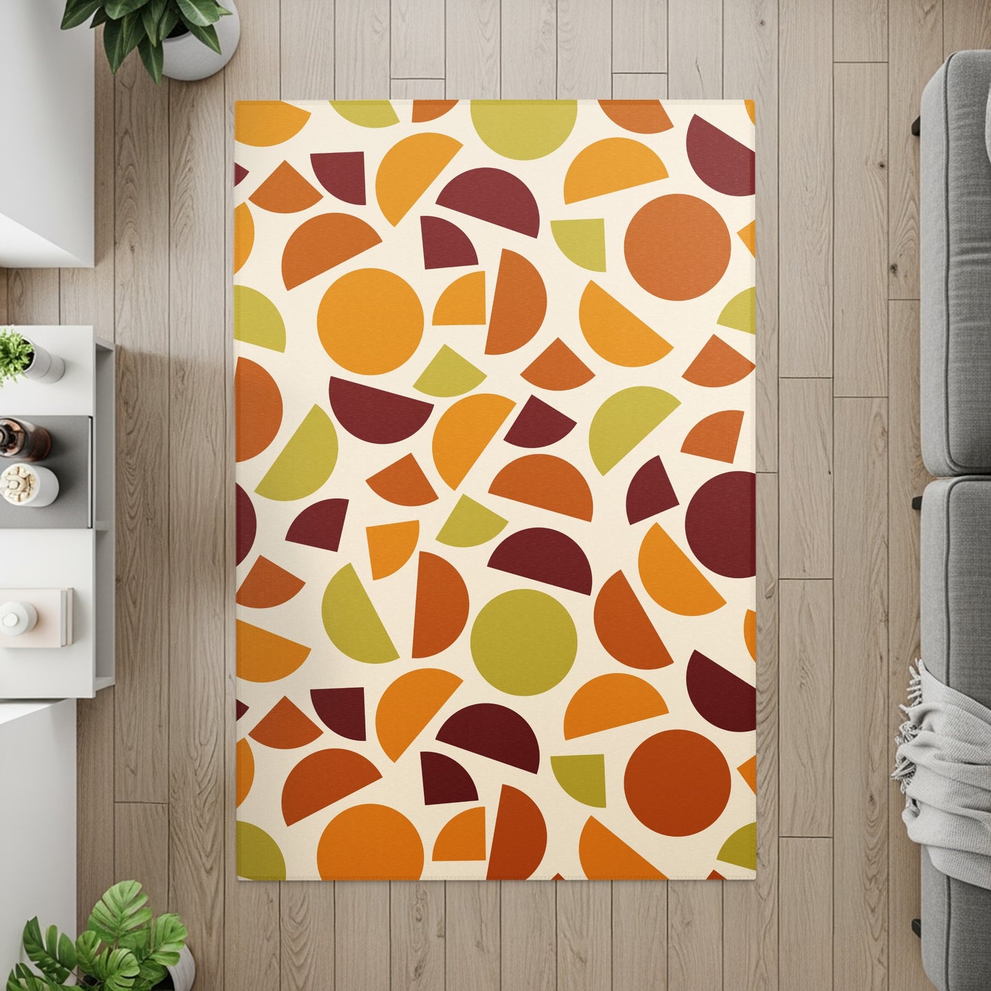 Rectangular rug with abstract pattern of circles and semi-circles in orange, green, and burgundy.