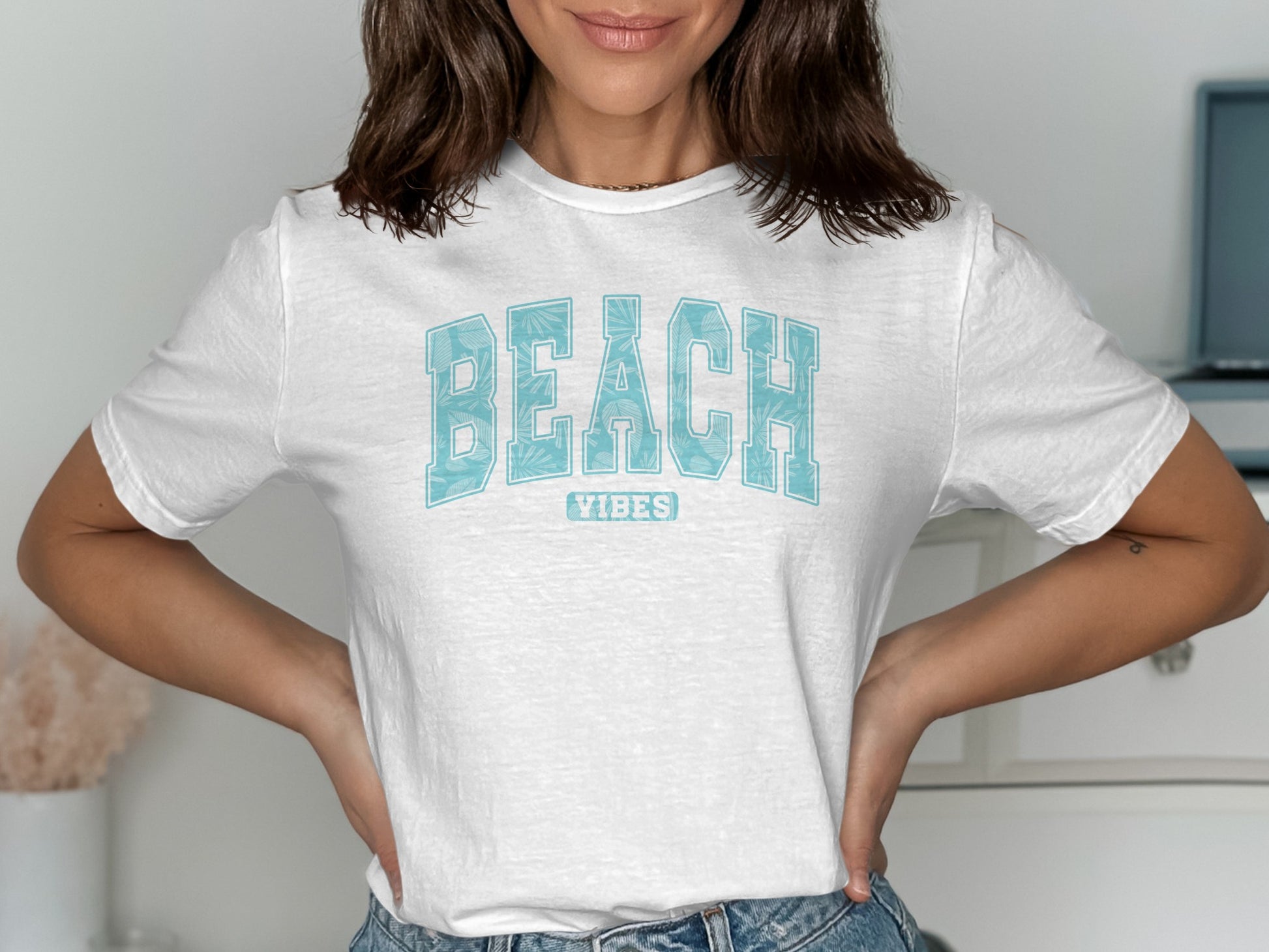 White t-shirt with "BEACH VIBES" in light blue distressed text.
