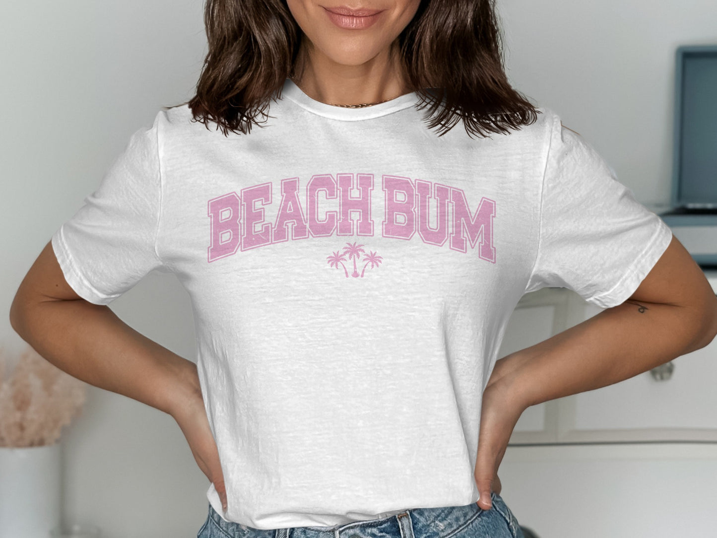 White t-shirt with pink "BEACH BUM" text and palm trees.