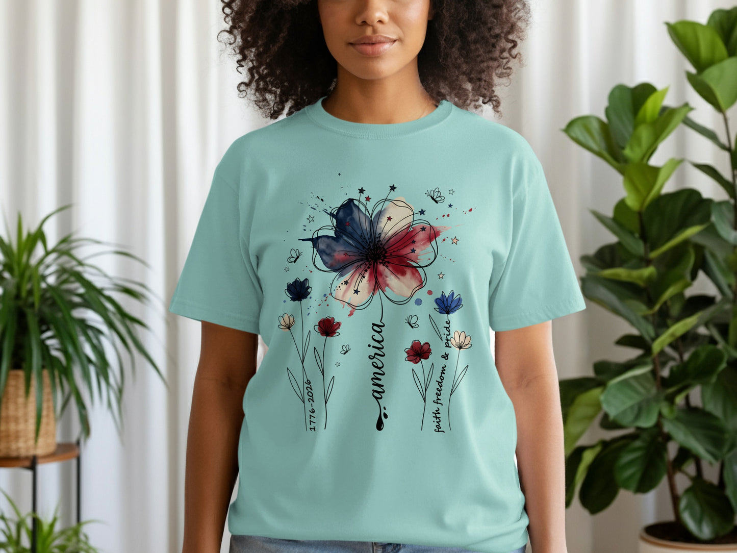 Light blue t-shirt with a watercolor flower and patriotic text.