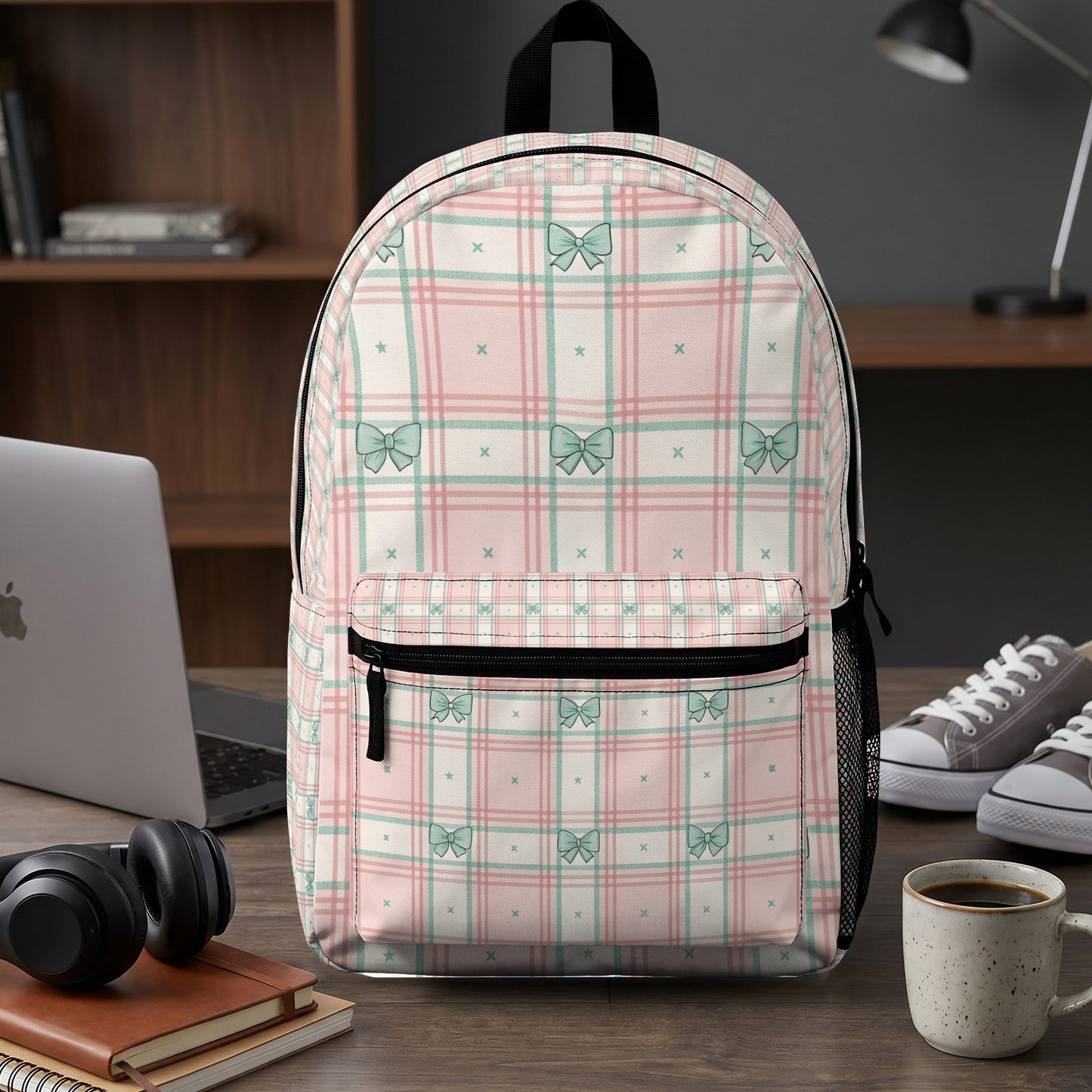 Pink and mint green plaid backpack with a bow pattern.