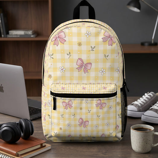 Yellow checkered backpack with pink bow and flower pattern