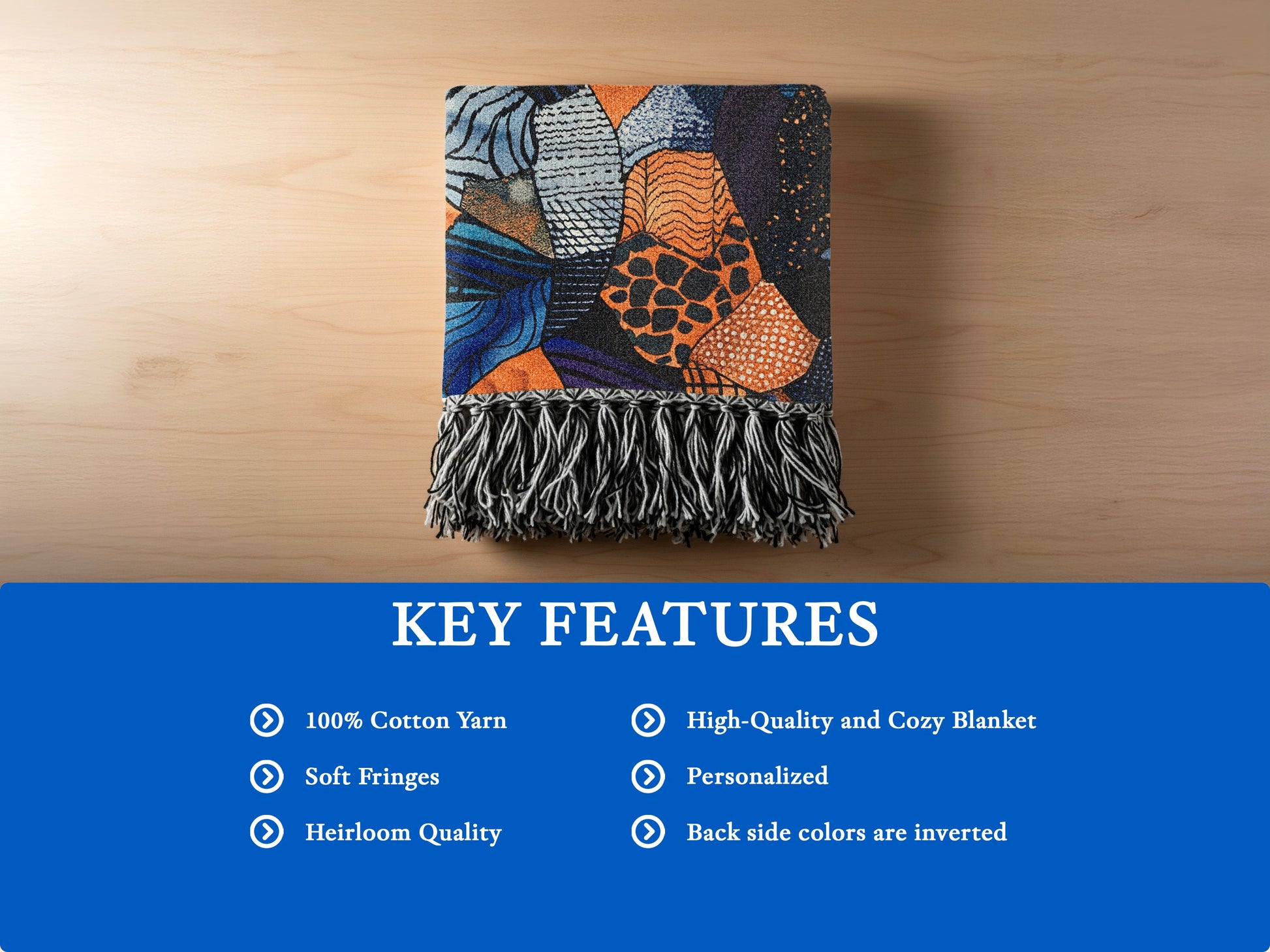 Colorful patterned throw blanket with soft fringes on a wooden surface.