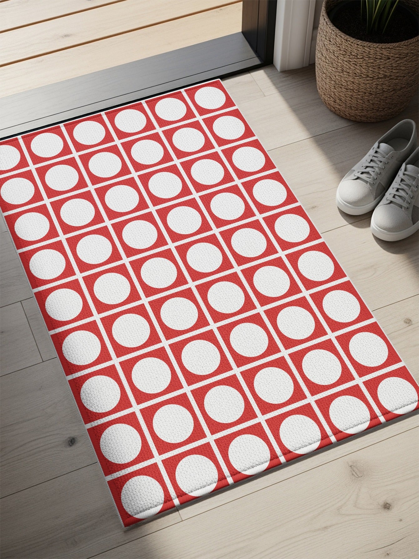 Red doormat with a white circle pattern inside red squares.