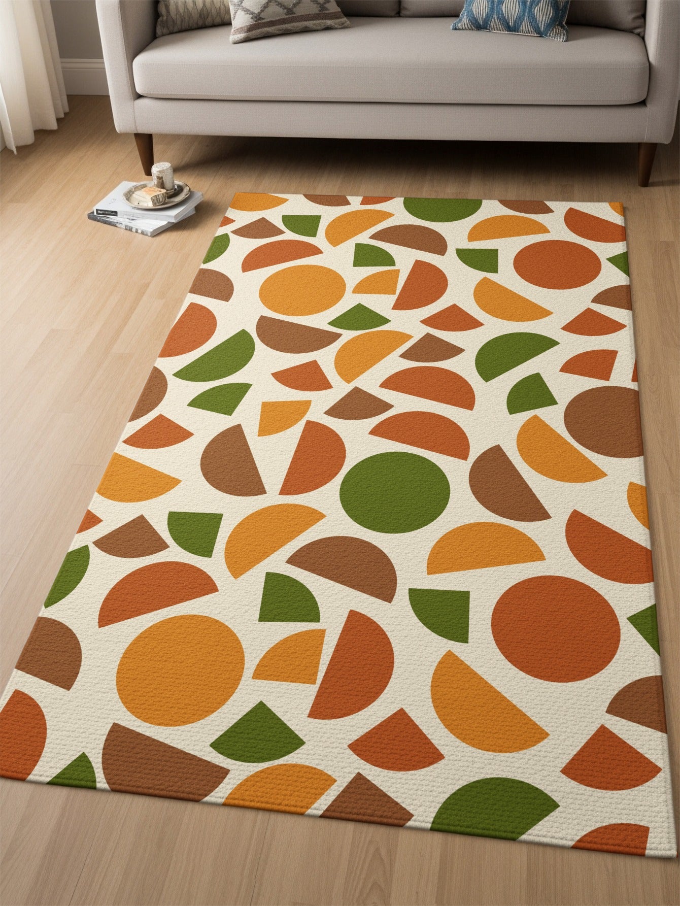 Rug with scattered circles and semi-circles in orange, green, and brown on a cream background.