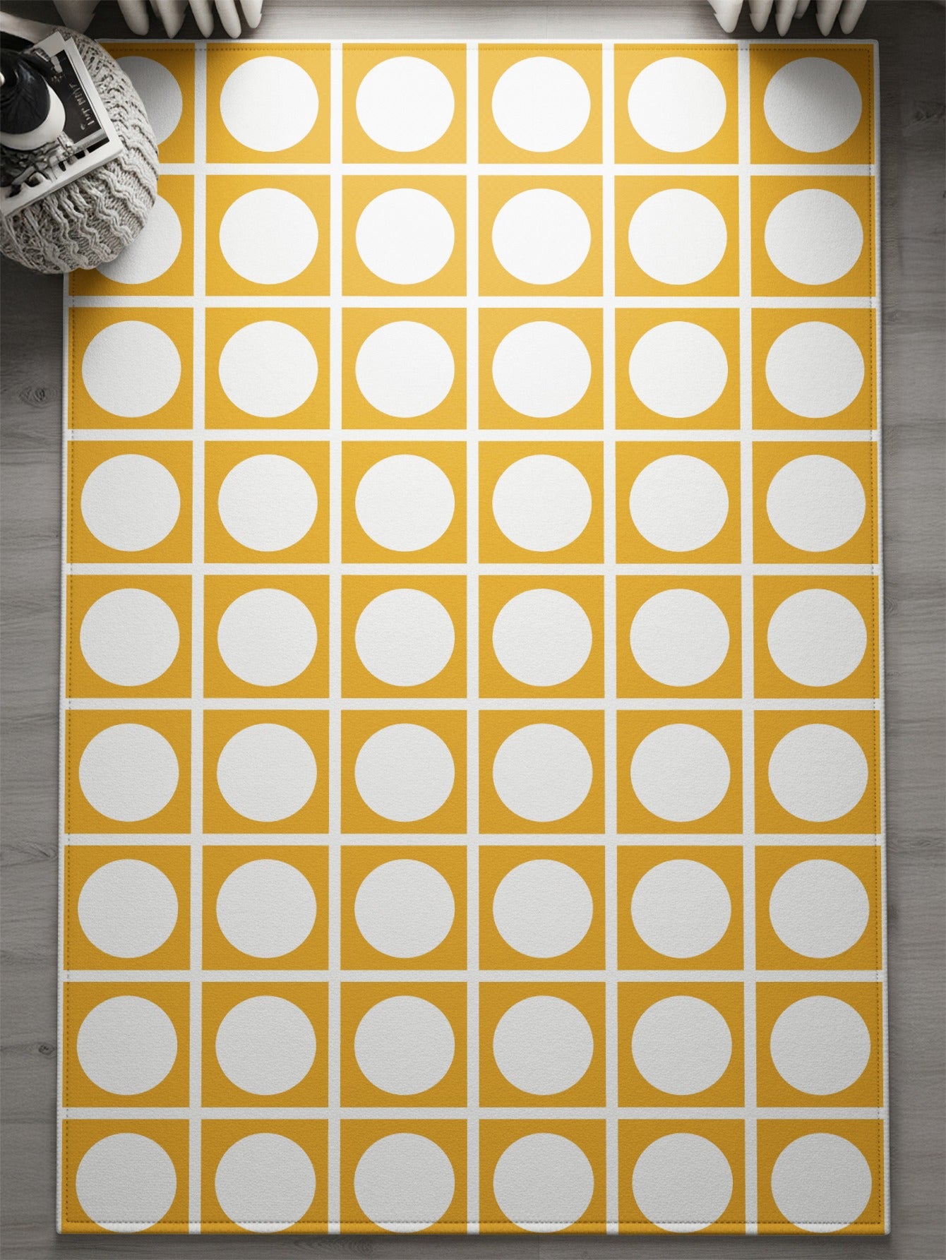 Yellow rug with a repeating pattern of white circles within yellow squares.