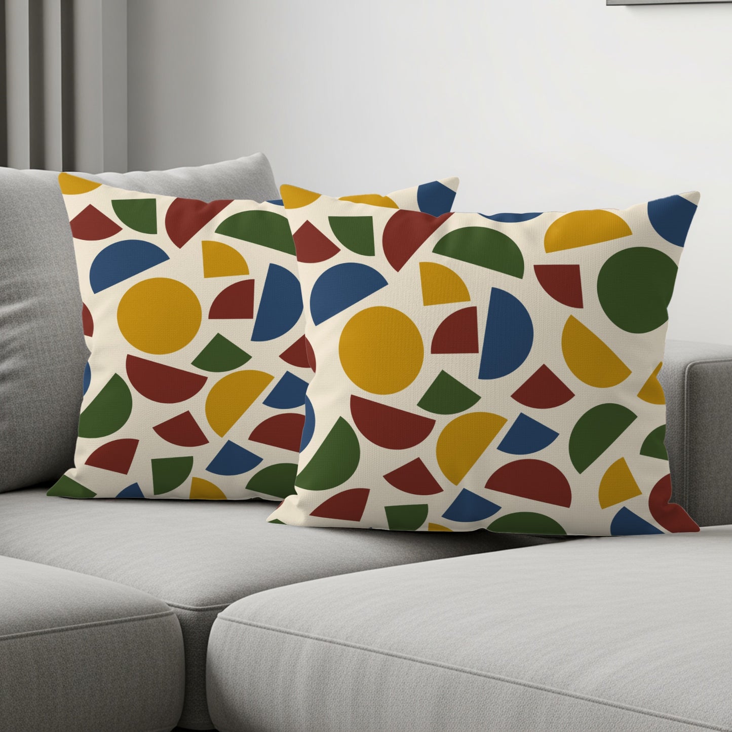 Two decorative pillows with a cream background and colorful geometric patterns.