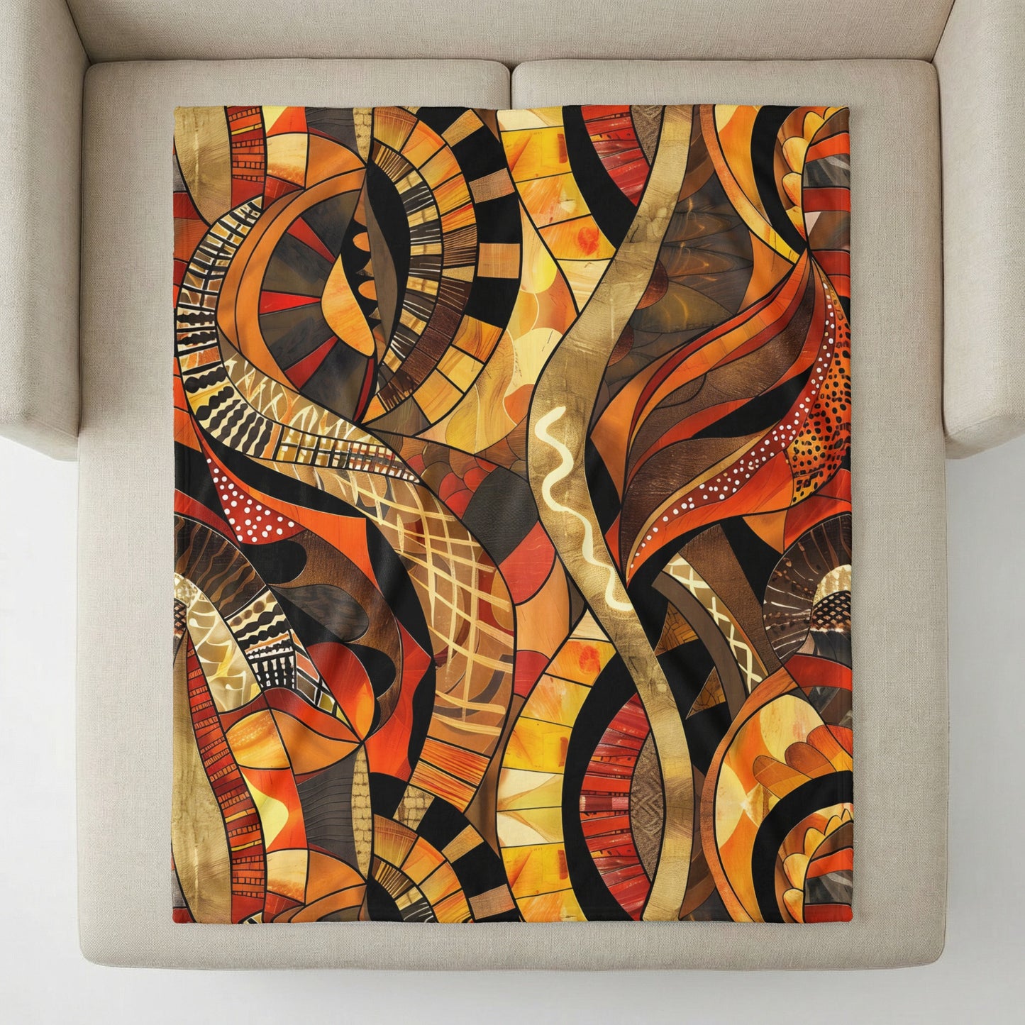 Abstract mosaic pattern in warm colors on a throw blanket draped on a sofa.